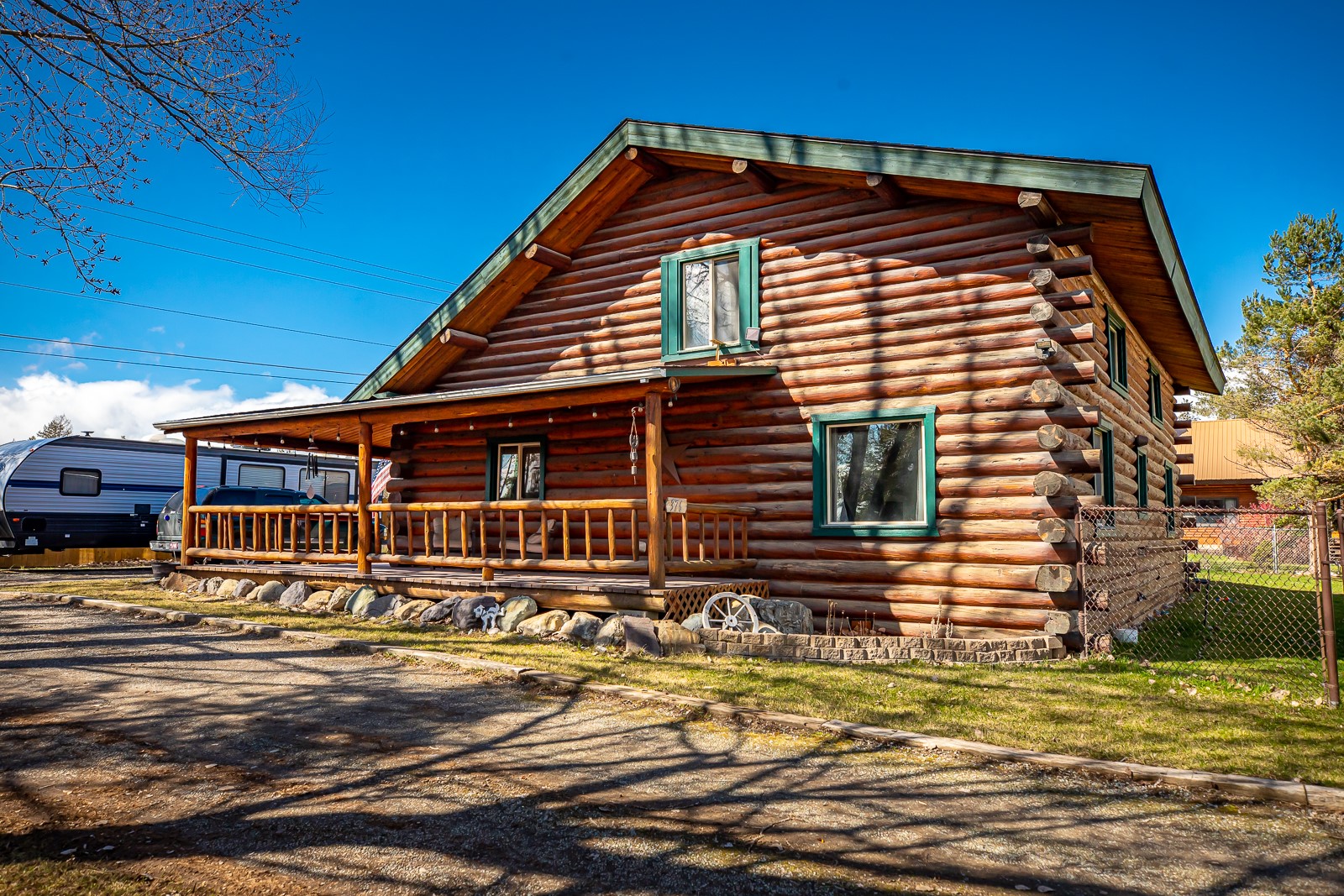 This Log home embodies rustic charm and comfort situated on a .45 acre parcel. VRBO potential. The spacious living/dining area features two natural gas fireplaces, perfect to heat the entire home and cozy up on chilly evenings.  The home offers 3 Bedrooms and 2 Full Baths.  The primary bedroom and laundry room are located on the main floor. The loft den offers a versatile space that can serve as a home office, library or cozy retreat for unwinding with a good book.  For hobbyists and do it yourself enthusiasts, a 24'x40' (960 sf) insulated heated/shop garage offers ample space for tinkering and storage, adding both functionality and value to the property. Outside the property is a haven to enjoy the outdoors, the fenced yard and pet door access are a plus to keep your pets happy and safe. A fire pit invites evenings to gather with friends under the starlit sky.  Additional parking for RVs and Boats ensures that adventures are always within reach. VRBO opportunity/Short term rental. Conveniently located in Happy Valley, you will have easy access to the charming town of Whitefish and all it's amenities along with other Flathead communities.  You can enjoy the nearby Happy Valley State Trust lands with 50 trails for mountain biking, hiking or a stroll with your pet.  This log home is an idyllic retreat for those seeking a quintessential Montana lifestyle.  Call Ellie Johnson at 406-250-1575, or your real estate professional.