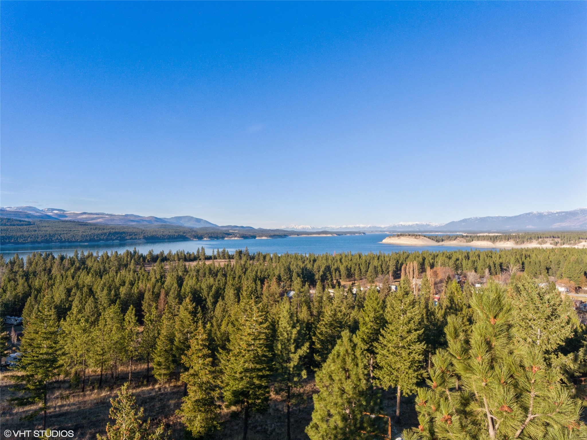 Elk View Estates Lot 3, 3.13 acres is like the VIP section for views, offering jaw-dropping panoramas of Lake Koocanusa, the Tobacco Valley, and even a peek at Canada! Just a stone's throw away from Abayance Bay, you can zip over in your side-by-side in a matter of minutes! With private and public boat launches nearby, you're set for aquatic adventures. The lake has a paved trail to accommodate a bike ride with lake and mountain views at any time! The property is located just a little over an hour from three snow/ski resorts and is minutes from thousands of acres of public land. Glacier International Airport and Glacier Park are a little over an hour away and Canada is less than 10 minutes. All of this is set in one of the lowest elevations in Montana which makes for Montana recreational living at its finest. For more info call Terry Comstock at 406-250-7722 , Colter Comstock 307-431-9787 or your Real Estate Professional. Amidst the timberlands of northwestern Montana, north of Libby along the Kootenai River, Rexford, Montana lies 7 miles from the Canadian border. The Purcell Mountains and Salish Mountains surround Rexford making it a recreation lovers paradise. Enjoy camping, hiking, hunting, snowmobiling, boating, and rock climbing (at nearby Stone Hill). It’s also a great location to begin the Lake Koocanusa Scenic Byway, a 67-mile route around the lake that connects Libby and Eureka. Nearby is the Ten Lake Scenic Area of the Kootenai National Forest which encompasses 15,700 acres. The area offers more than 89 miles of trails for remote backpacking and exploring. The high alpine lakes offer fishing and hiking opportunities through rugged mountain terrain of elevations of more than 7,800 feet.
 
Eureka, Montana centralizes along a two-mile stretch of Highway 93 in the lush Tobacco Valley. The scenic area is surrounded by the Kootenai National Forest and the backside of Glacier National Park. All year round there are activities and ways to enjoy the great outdoors. The small town is minutes from the Canadian border and also features the number one golf course in the state, the Wilderness Club. Eureka is 1 hour from three snow ski hills, 1 hour from Glacier and Waterton National Parks, and 1 hour from Glacier International Airport. Lake Koocanusa has gorgeous white-sand beaches and offers incredible fishing and boating!