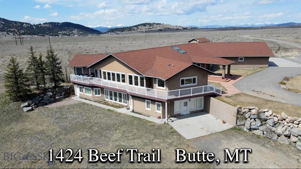 Presenting a Montana masterpiece that is tucked away on 65 acres and is surrounded by The Rocky Mountains. It offers a perfect mix of having "plenty of elbow room" but still being only minutes to town (Butte) on maintained roads. As you approach this unique property, a sense of anticipation fills the air knowing you are about to enter a realm of enchantment—a place where privacy reigns supreme and breathtaking vistas unfold before your eyes. A grand foyer welcomes you into a luxurious and elegant house with architectural features and ornamentation that make this estate extra-special. Step into any room and you will be greeted by spectacular panoramic views of the majestic mountain ranges. The heart of the home holds a secret—a terrarium that exudes soothing energy tranquility. Multiple primary suites, each with its own walk-in closet, provide comfort and privacy. The basement is a walk-out and an elevator is available to get you from floor to floor. The wrap around deck allows a seamless transition from the indoor to outdoor the spaces. 3-car attached garage. For those who cherish the equestrian lifestyle, a charming horse barn and corral await. Southwest Montana is rich in recreation, wildlife and scenery and this magnificent property was built for comfort, privacy, and total enjoyment of life!