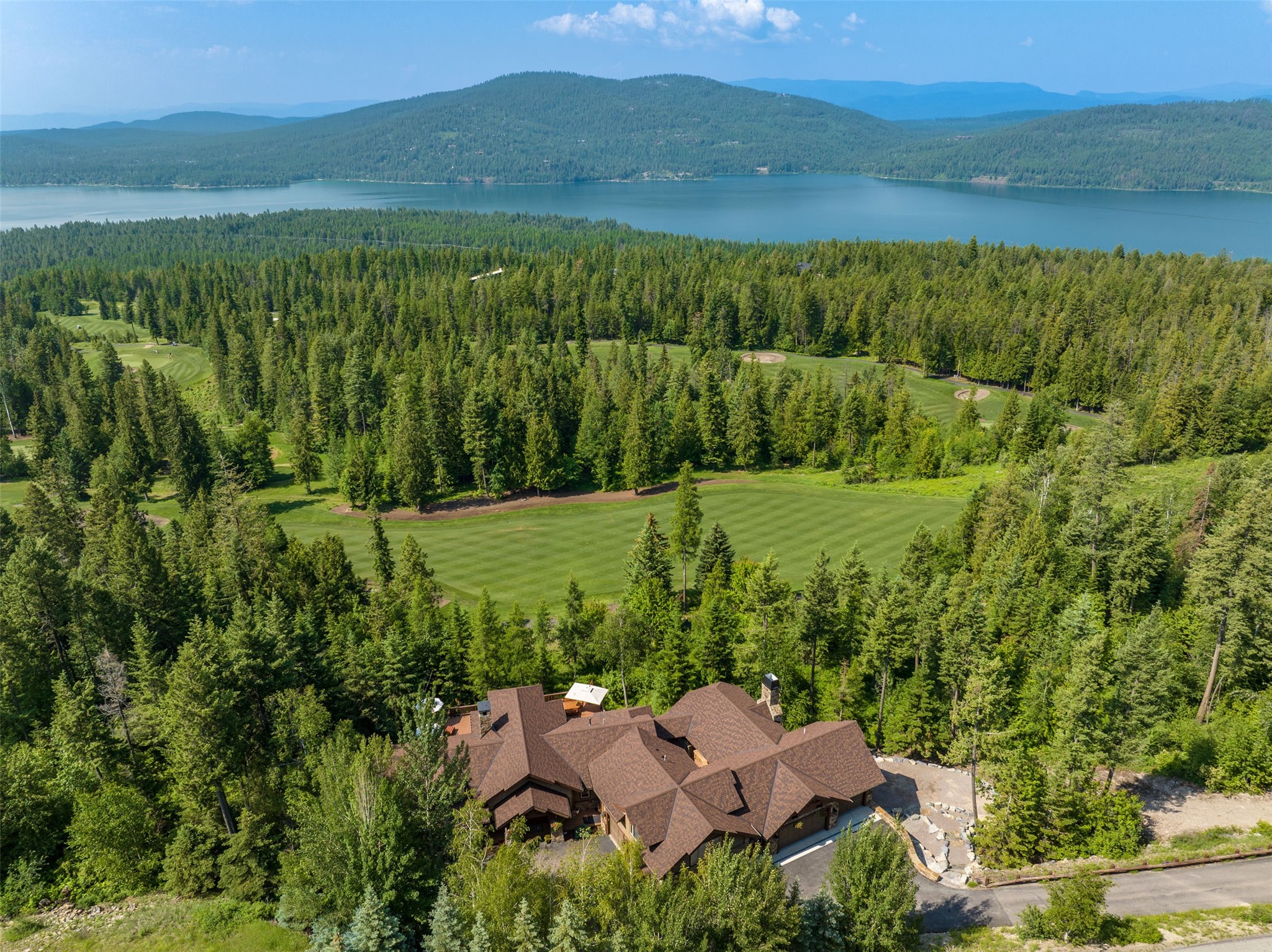 A rare find in the exclusive Iron Horse community…enjoy 1.53 acres of privacy overlooking the 13th fairway of the Tom Fazio-designed golf course with stunning views of Whitefish Lake. Built in 2000, this property has been extensively remodeled throughout and just completed an additional covered deck and 3 car garage for a total of 2 garages with 5 spaces. The main home is an elegant 5,819 sq ft with 3 large bedroom suites plus 2 additional powder rooms. The 4th bedroom suite sits on its own with a private entrance above the garage. The original deck off the great room was replaced with trex decking and heavily reinforced, the additional deck is covered and features a fireplace, built-in Evo cooktop, and grill. Offered fully furnished, turn-key with some seller exclusions. See the property features sheet for more details. Contact Stephanie Skinner, 406-261-8430, or your real estate professional.