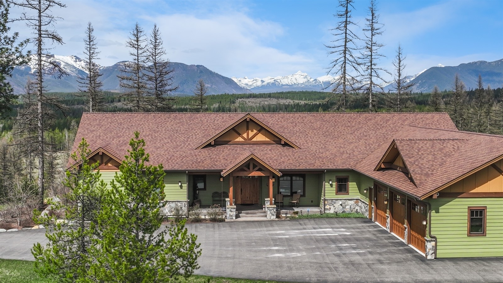 The majesty of Glacier National Park is on full display from this private estate on 20 acres, and the design of the well-appointed 4747 square foot single-level home takes full advantage of those views. Enjoy the mountainous panorama from the large windows inside, or get one step closer to nature from the covered back deck. The impressive interior boasts vaulted ceilings, an open floor plan, spacious gourmet kitchen with large island and pantry, huge primary suite with 2 walk-in closets, 2 spacious guest bedrooms with a jack & jill bathroom, 2 half baths, and a bonus wing that could be used for recreation, hobbies, or customized into a guest apartment. The home has an attached triple garage, equipment garage & workshop, and a detached triple-bay garage. This is the magnificent Montana living you've been waiting for! Call Bill Leininger at 406-253-7333 or your real estate professional.