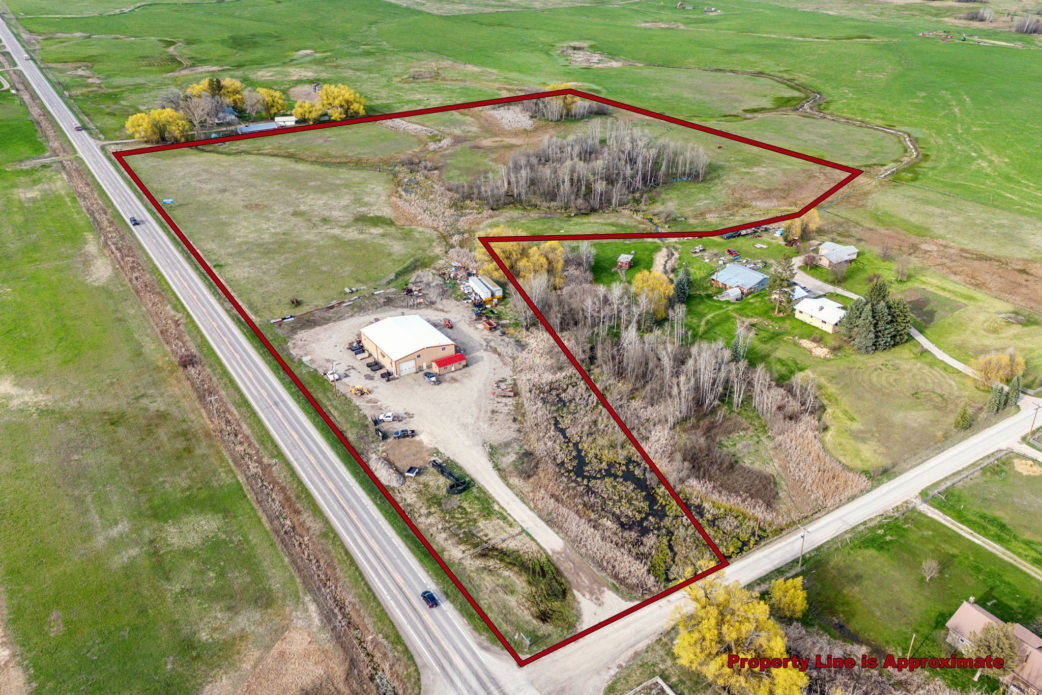 4800 sq. ft. Light Industrial Building on 20+ acres with beautiful Mission Mountain views, 1/4 mile of Hwy 93 Frontage just north St. Ignatius, MT. Useable property area estimated at 5.2 acres.  The 60’x80’ metal building has power & is insulated on approximately 1.45 acres.  Operable windows on all sides, overhead doors & man doors on 3 sides provide ample access, natural light & ventilation. Open floor plan and 16ft + clear ceiling height offers an array of uses. Holding tank for bathroom vs septic due to ground water. Easy HWY 93 access. Additional 3.75 acres deal for additional warehouse or storage units. Call Jason Shreder @ 406-370-4436, Katie Ward @ 406-596-4000 or your real estate professional. New well must be drilled within 4 months of closing. Current well servicing property is on neighboring site.