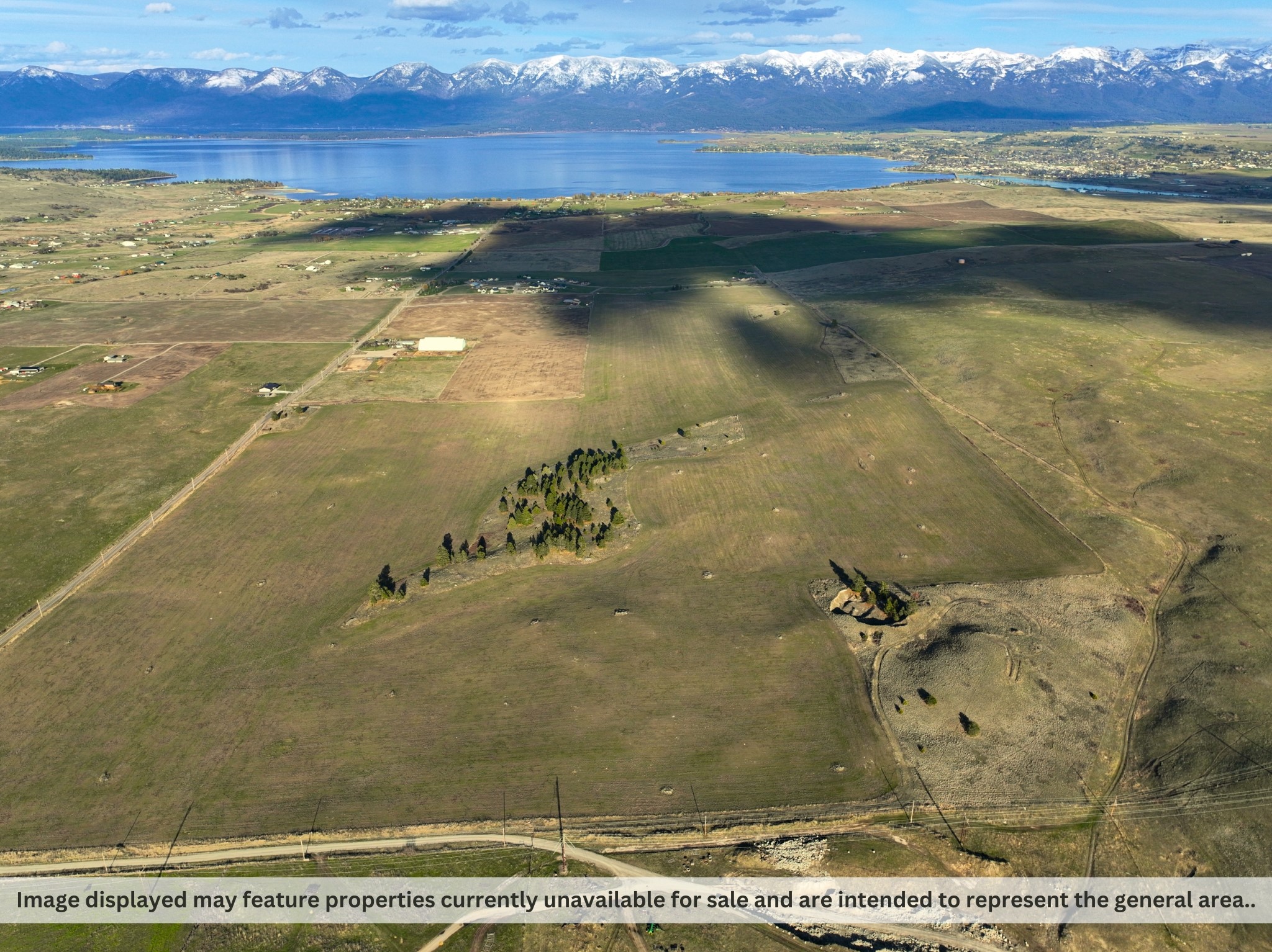 Discover this versatile 240-acre tract, minutes from Polson, MT, offering unzoned land with potential for substantial development. Located off Tower Road, the property features varied terrain with stunning lake views and is currently income-producing with an agricultural lease for alfalfa. Perfect for developers looking to create a residential subdivision or for continuing agricultural operations. Its proximity to other developments and easy access enhances its appeal for both private estate and commercial uses. Explore the endless possibilities by contacting us today for more details or to arrange a viewing. For more info text: BRE to: 59559. For additional details call Jeremy Williams @ 406-926-6767 or your Real Estate professional.