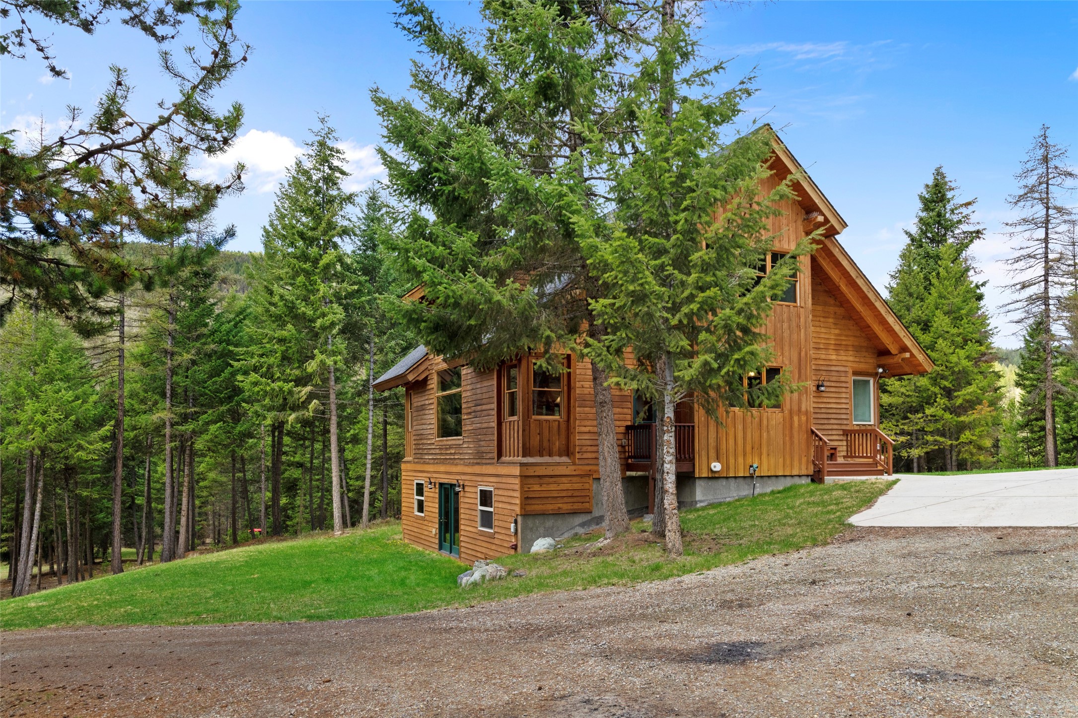 This custom timber-framed home on 21+ acres—surrounded on two sides by thousands of acres of national forest—is a slice of true Montana living!  Boasting endless wildlife, a year-round creek, and complete privacy behind a private gated entry and electric perimeter fencing, it is rare to find such a stunning, “parked-out” property less than 30 minutes from Costco and downtown Kalispell.

The 3400+ sqft meticulously maintained home was featured in Timberhome Living Magazine, and offers plenty of natural light from the oversized windows, gorgeous hand-pegged Douglas fir timbers, and breathtaking vaulted ceilings.  The home’s 4 bedrooms, 3 bathrooms, 2 large family rooms, and bonus loft bedroom are heated by a recently upgraded high-efficiency radiant floor system. The top floor is highlighted by elaborate balusters, exuding a peaceful, airy feel throughout the home. The property also includes a nearly 2,000 sqft heated and insulated shop, and running water to one of four fully-fenced pastures.  Recreational opportunities abound on the extensive Wild Bill trail system, and nearby Blacktail Ski Resort.  Property can be subdivided into two 10+ acre parcels, with the beautiful Wild Bill Creek marking part of the boundary between parcels. Call Corey Olofson 406-253-0531, or your real estate professional for more information.