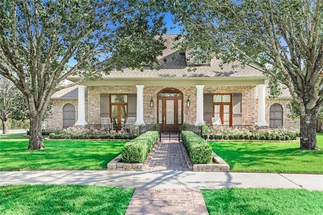 Discover Southern charm at its finest in this exquisite Louisiana-style home situated on a corner lot in Southdown Subdivision. The brick front porch welcomes you, featuring a glass-centered door, French windows, and gas lanterns. Inside, the beautiful hickory flooring flows through the foyer, family room, and formal dining area, accented by triple crown molding that adds a touch of elegance. The chef's kitchen is a culinary delight, boasting brick floors, GE appliances, granite countertops, and a 6-burner gas stove. Retreat to the screened patio and immerse yourself in the tranquility of the 32' x 37' courtyard-style oasis, complete with a fireplace, full kitchen, and charming gas lanterns. This home offers 4 bedrooms, 3 full baths all down with a bonus room up. Generous space for indoor and outdoor entertaining. Experience the epitome of Southern living.