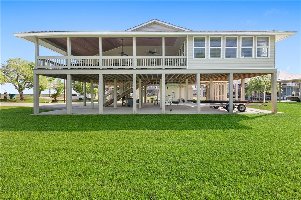 Absolute stunner! A true Sportsman's paradise! Sitting on three lots in highly coveted Northshore beach subdivision, this home is the epitome of Louisiana living! One boat slip and launch on the canal side of the street and another boat slip with room for two boats PLUS another boat launch behind the house on the third lot! Direct deep water access to the Lake! Super low assumable flood insurance! Brand new roof just installed which will allow for the absolute lowest insurance premiums! Tons of storage downstairs and around the property for all of your outdoor toys, cars, boats or RVs! Huge deck covered off the front of the home with absolute stunning views of the canal and march area, which offers the most beautiful sunsets you could imagine! Perfect spot for crawfish boils or family gatherings. Enter the home and you are greeted with soaring ceilings covered in wood planks, and spiral staircase leading up to the loft area. Open kitchen/living area. Three bedrooms on the main floor with the huge primary suite off the back of the home. Tons of windows throughout the home help bring in lots of natural sunlight. Recent upgrades include new windows (transferrable warranty option), new roof, plus a water filtration system. Unbelievable location with views of the lake and canals. Short commute to New Orleans and nearby all of Slidells best restaurants and shopping. Don't miss out on this one!!