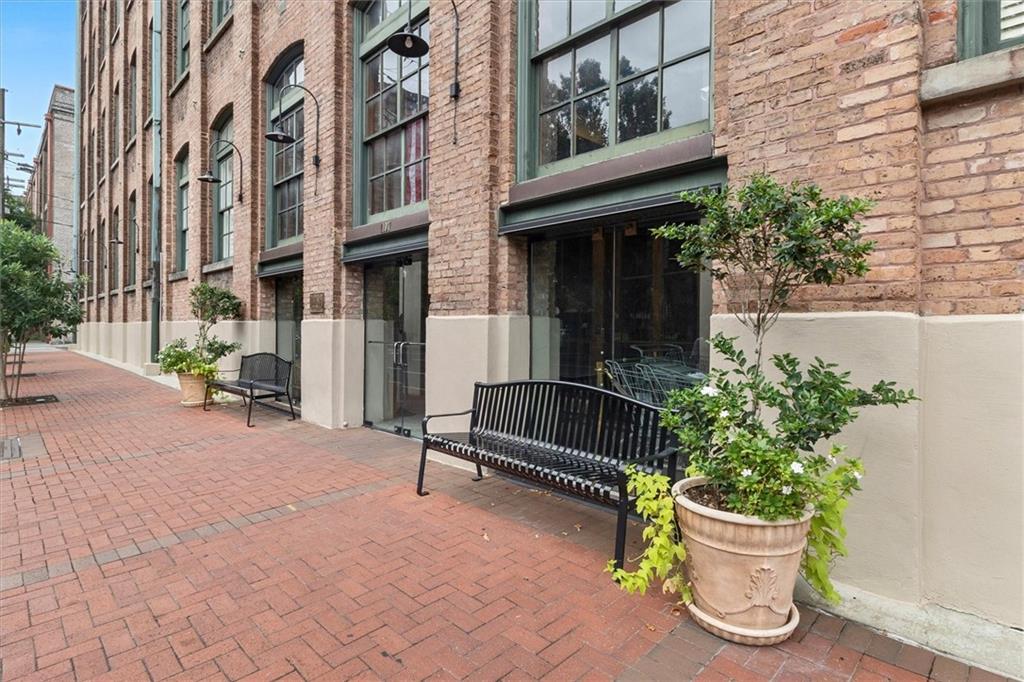 This condo is centrally located in the historic warehouse district in the Fibre Mills Condominium Complex. One walk through this condo is all it will take for you to fall in love with the city itself. This condo has an exposed brick wall giving it the perfect old New Orleans touch. The chandelier in the living area gives the condo a feeling of elegance. The tall windows in the living area allow for a beautiful street view. Condo also has a in unit Laundry room. Each floor in this building has its own trash room and bike storage room for residence convenience. The condo amenities include a 24 concierge desk service, beautiful lobby, 1 parking spot with a gate, a courtyard, heated pool/spa/jacuzzi, green space for the pets, Building Chiller(this helps cut unit owners electricity expenses during the hot summer months, and a fitness/lifestyle center. There is also a back up generator on grounds to power lobby and common areas throughout the complex during power outages. You do not want to miss this one. Special assessment has already been paid by the seller.