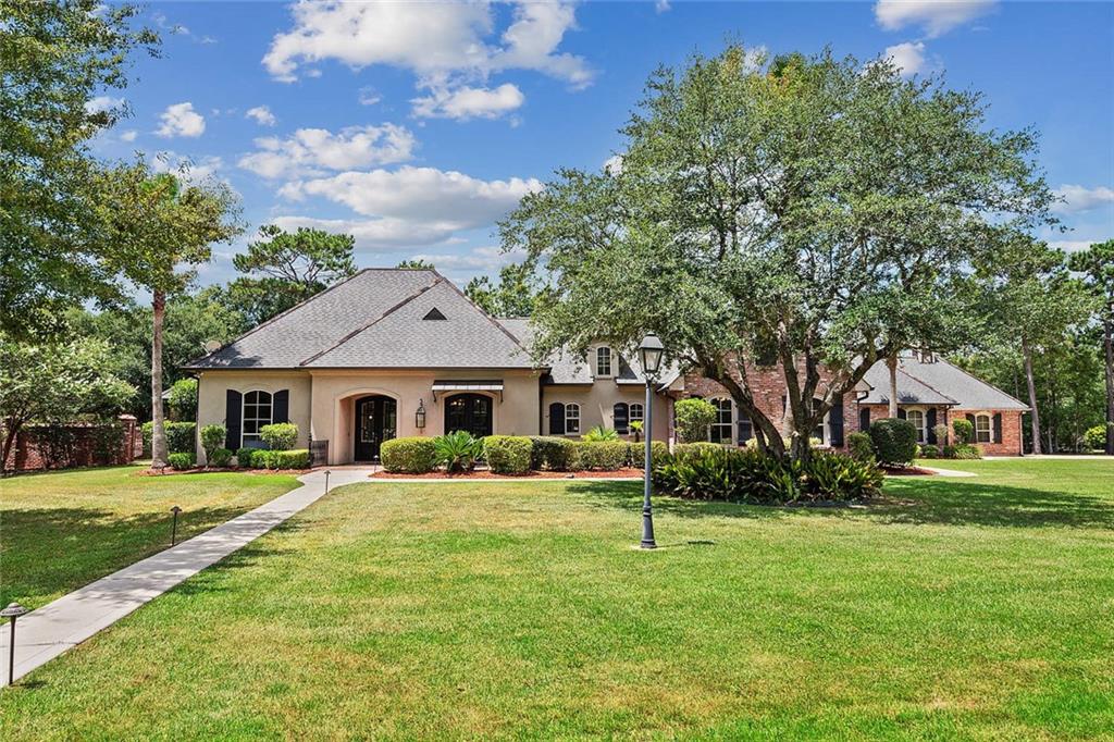 Nestled graciously on an expansive acre, this impeccable single-story family residence is a true gem, elevated by its corner lot positioning. The open floor plan serves as the heart of this home designed with the discerning entertainer in mind. Spaciousness intertwines seamlessly with functionality setting the stage for cherished gatherings. The allure is amplified by the presence of floor-to-ceiling windows where natural light highlights the elegance of the interiors. French doors beckon you to step outside and explore the symphony of elements that define the outdoor oasis. Crafted with meticulous attention, this outdoor haven is an enchanting escape from the everyday. The pathways paved with the character of Old Chicago brick and the charm of slate pavers guide you through a mesmerizing landscape. As daylight fades the landscape is illuminated by the soft glow of gas lanterns creating an ambiance that is nothing short of magical. Central to this oasis is the inviting heated pool accompanied by a jacuzzi that whispers of relaxation. Cascading fountains provide a soothing backdrop while the majestic fire feature takes center stage. Beyond the main residence a guest house stands as an invitation to comfort. Here, a generously appointed bar sets the scene for festive evenings while a meticulously designed bathroom and steam shower promise an indulgent escape. Practicality and luxury converge in the form of a four-car temperature-controlled garage offering secure haven for your vehicles + full motor home hook up. Unforeseen disruptions are but a distant concern courtesy of the whole house generator that stands ready to ensure uninterrupted comfort. In summary, this family home encapsulates the essence of refined living, your dream home awaits, where luxury meets practicality!