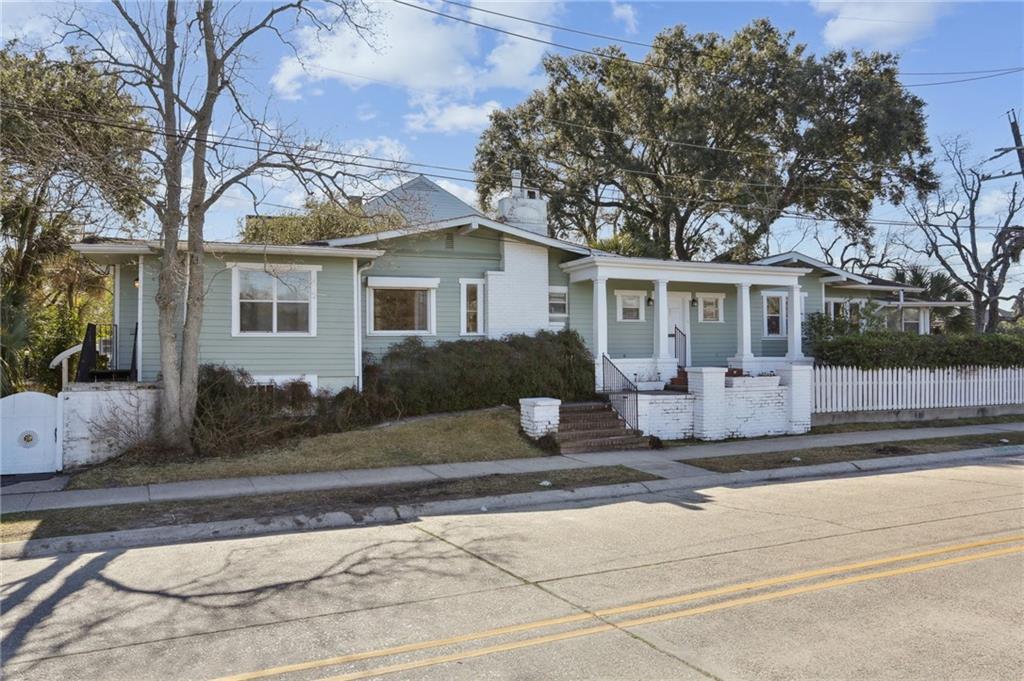This cottage fronts Bayou St. John on one of the most desirable streets in New Orleans. On a corner lot at the bayou’s bend, the home offers 180° of unobstructed bayou views. This property boasts 173' of bayou frontage! This incredible vantage point also provides views of City Park & the Carrollton/Canal streetcar line. You’ll have a front row seat to events on the bayou and City Park along with a short walk to the Fairgrounds for Jazz Fest. The home features two bedrooms + a bonus room & a sunroom off of the primary bedroom, a large living room w/wood burning fireplace, big dining room, & kitchen w/breakfast nook. The bathroom, millwork and original wood floors provide vintage charm. Basement provides 1,500+sqft of storage/workshop space. Lovely white-picket fenced yard. Driveway.  Amazing renovation opportunity in an unbeatable, unique location.