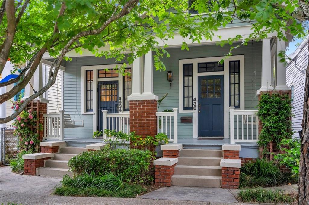 This charming Arts and Crafts home has a beautiful, covered front porch offering amazing views of this tree-lined street. Nestled one block between St Charles Ave and the levee, this home features an abundance of natural light with many gorgeous original wood windows, tall ceilings, antique heart pine wood flooring, and original architectural details throughout. The main house features 3 bedrooms, 3 baths and a HUGE great room complete with a wet bar and beverage fridge and 3 sets of French doors connecting to a large, covered back deck. A hidden closet under the staircase provides an abundant storage area. The kitchen has no shortage of storage space as well, featuring a gas range, quartz countertops, SS appliances, a large pantry and custom built-ins. The home features a 500 sq ft. 1 bedroom/ 1 bath granny flat, mother-in-law suite or rental property. Renovated to add the camelback in 2019, this well-maintained house gives the owner the flexibility to generate income or have space for extra family/friends.  The backyard has a large shed/workshop and rear, gated driveway with an access street behind the house. House has 2 electrical meters and 2 water meters. X Flood zone.