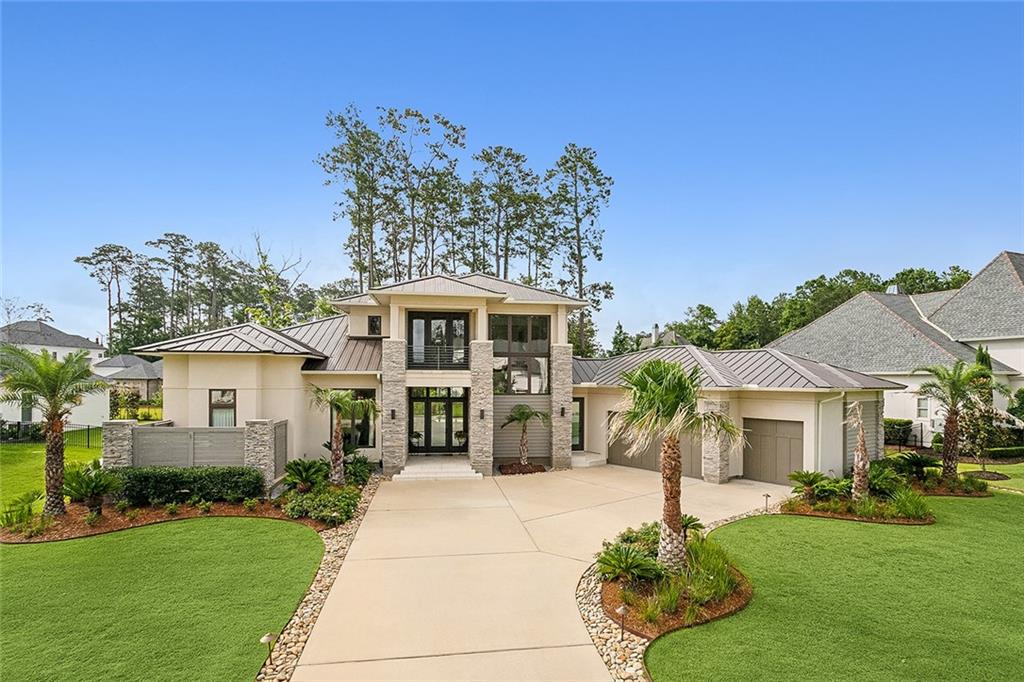 The carefully curated materials, colors, fabrics and furnishings of this remarkable home come together to create a truly unique and private residence located in the heart of The Sanctuary, Mandeville’s premier luxury community. The scale of the architectural features create a living and entertaining venue that “lives” much larger than the manageable 3730 living square feet would suggest, especially when the folding doors of the living room and 2nd floor guest suites are opened to the back yard veranda, outdoor kitchen, solana and spacious 2nd floor decks, effectively incorporating the unique infinity-edge pool into the interior living spaces. The first floor is home to the gourmet kitchen, living and dining rooms, an office with a full bath that serves the outdoor spaces and the master suite. The second floor features a generous loft space, two guest suites, a balcony facing the front of the property and a large deck overlooking the back yard oasis. Request a list of the finishes and amenities for this home as they are too many to list here. The Sanctuary is an environmentally planned community only minutes from The Causeway Bridge and home to miles of nature trails, a Health & Activity Center, fitness center, tournament-size swimming pool, three tennis courts, a ball field and an active homeowner’s association.