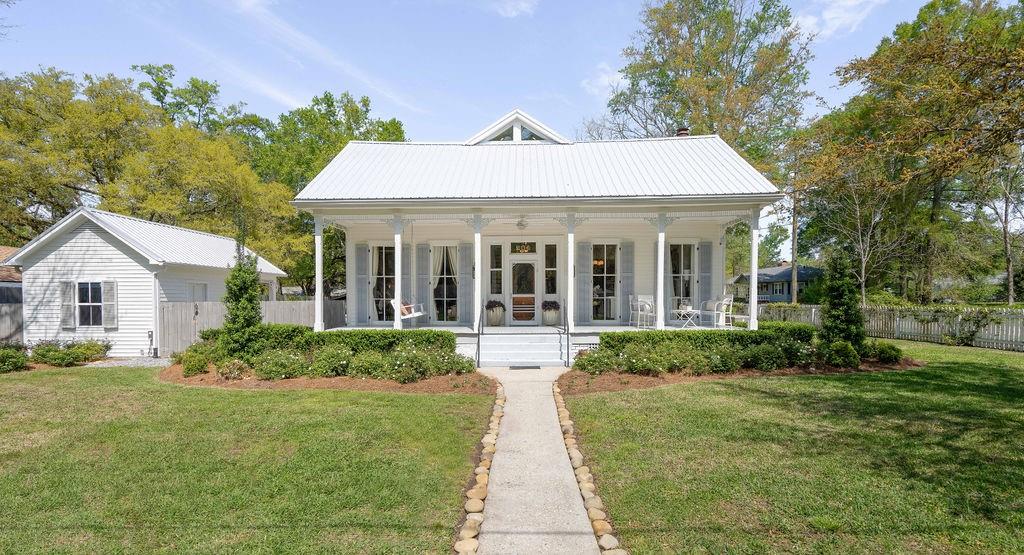 Welcome to this beautifully renovated historic home in the heart of Covington, LA. This charming property offers the perfect blend of old-world character and modern conveniences. The main house boasts hardwood floors, elegant crown molding, and   intricate detailing throughout. The spacious living area is perfect for entertaining, while the renovated kitchen features new cabinets, stainless steel appliances, and quartz countertops. Outside, the large lot includes beautiful landscaping, exterior lighting, and a 383 +/- sq ft guest house with a bedroom + full bath. Relax in the cabana by the sparkling pool on hot summer days or enjoy a quiet evening on the large screened-in porch overlooking the pool and backyard. The Sellers have made extensive updates and have lovingly renovated this home. Please see the Amenities/Upgrades for a complete list in the attachments. New metal roof, new whole home Kohler Generator, new tankless gas water heater, 2 new HVACs in 2019 with all new duct work and vents...and so much more! This property is just a short distance from shopping, dining, schools, and entertainment options. Don't miss the opportunity to own a piece of history with all the comforts of modern living!