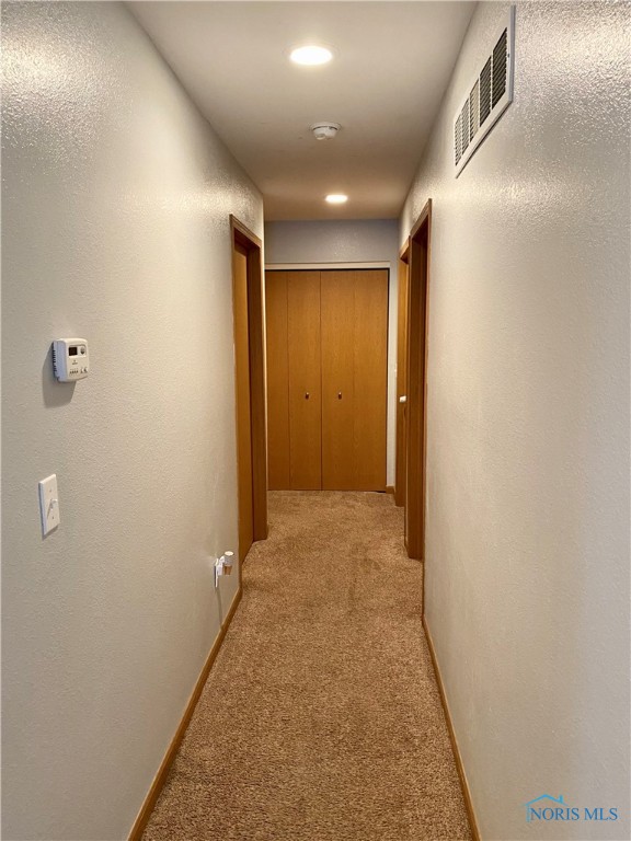 Hallway w/ linen storage.