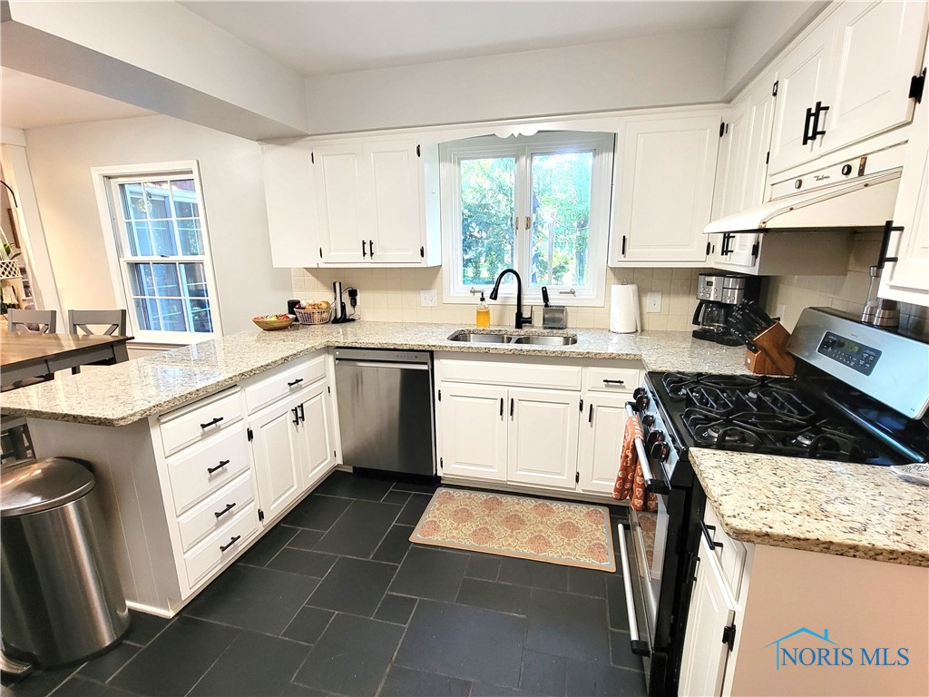 Kitchen has stainless steel appliances and granite counters