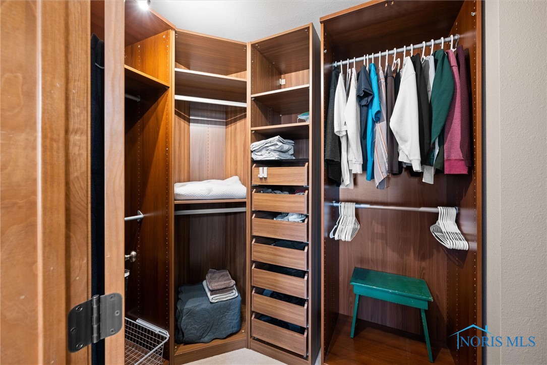 Primary bedroom walk-in closet with organizers
