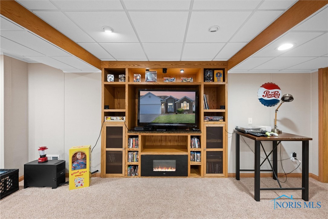 Built-in cabinetry for display and entertainment center also has a small electric fireplace