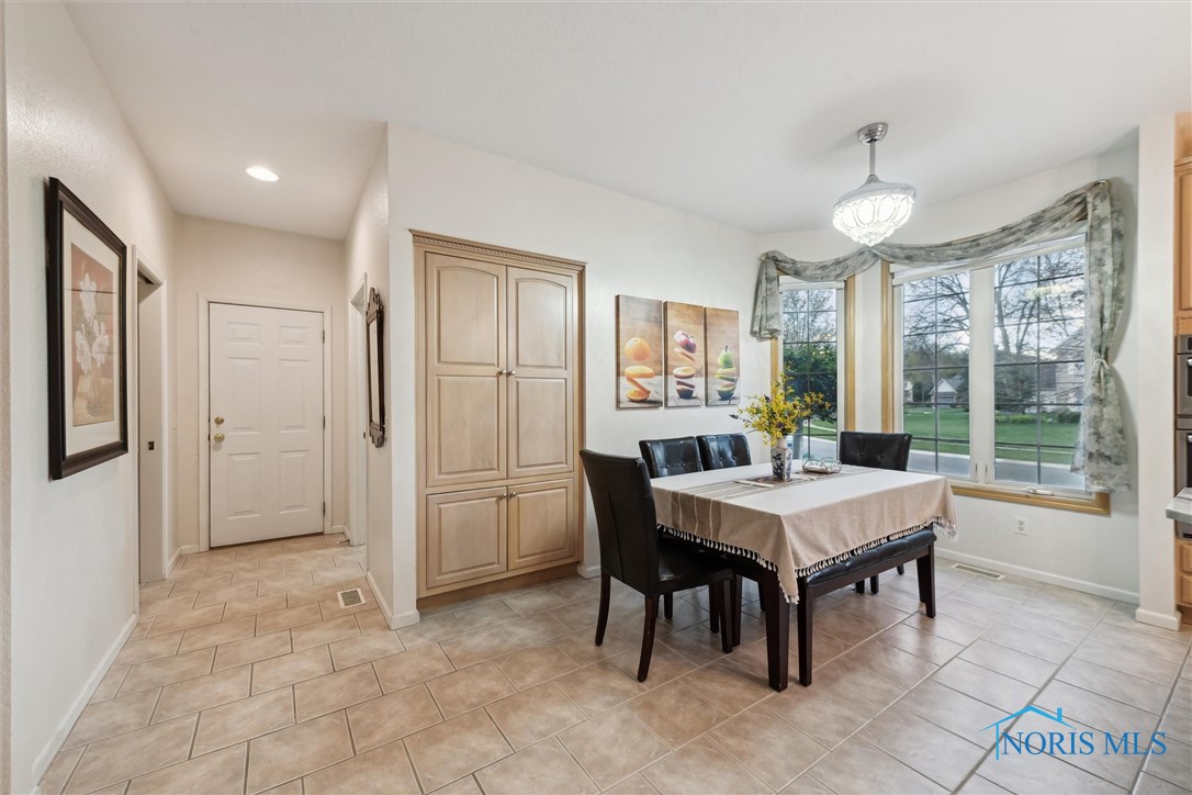 EAT IN KITCHEN WITH TILE HALLWAY LEADING TO THE LAUNDRY AREA AND HALF BATH. OPEN THE DOOR AND THE HEATED 4 CAR GARAGE IS THERE FOR YOUR CONVENIENCE.