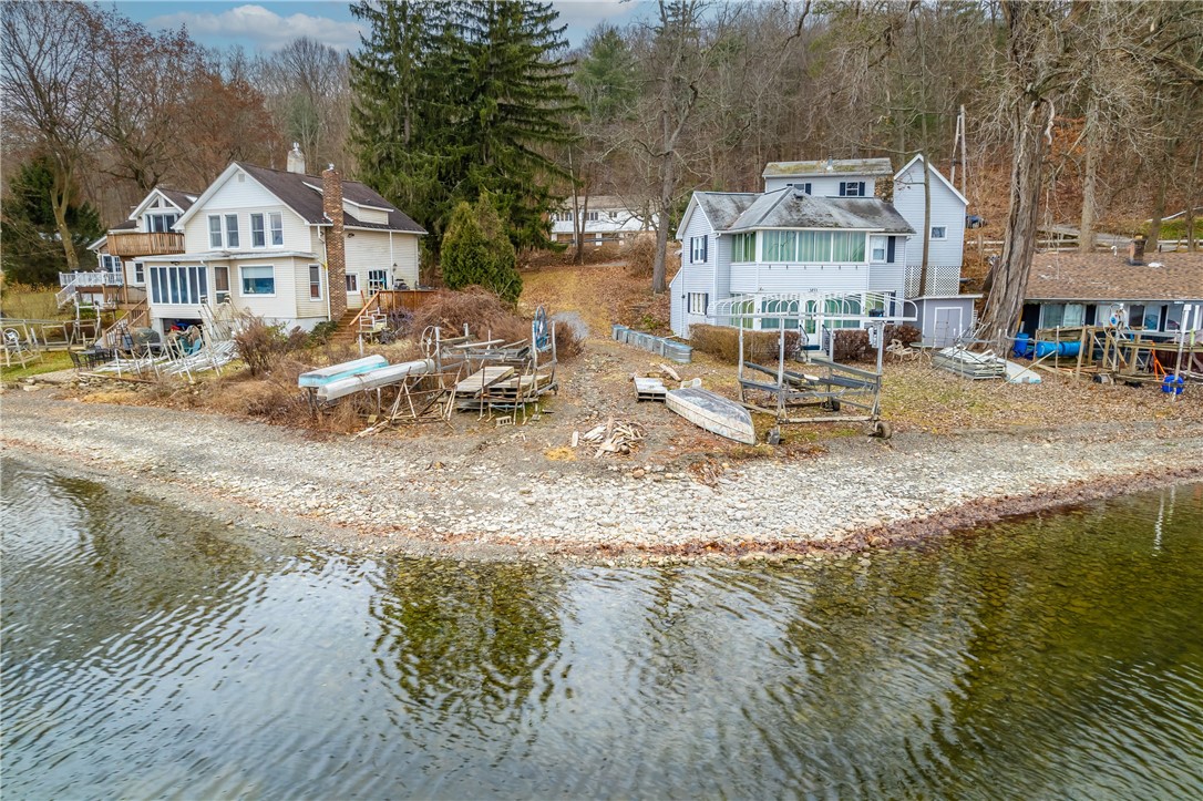 OPEN HOUSE: 02/04 @ 12PM-2PM. EXTREMELY RARE, TWO-FAMILY WATERFRONT PARCEL WITH 25' OF LAKE LEVEL WATERFRONT WITH A STONE BEACH ON CONESUS LAKE, PLUS APPROXIMATELY 17 ACRES WITH SWEEPING HILLTOP VIEWS OF THE LAKE. GREAT OPPORTUNITY TO BUILD YOUR DREAM LAKE HOME! TWO-FAMILY HOME FEATURES A LAKE STYLE THEMED TWO-BEDROOM UNIT WITH A WHITE & BRIGHT KITCHEN, PHENOMENAL OPEN LIVING WITH A WATER VIEW BALCONY, TWO SPACIOUS BEDROOMS & A FULL BATHROOM WITH LAUNDRY! 2ND UNIT: ONE-BEDROOM WITH PHENOMENAL OPEN LIVING LEADING TO A PRIVATE LAKE VIEW BALCONY, SPACIOUS BEDROOM & FULL BATHROOM & SEPARATE LAUNDRY! PLUS AMAZING FLEX SPACE FOR MORE POTENTIAL FINISHED SQ FT. EXCEPTIONAL INVESTMENT PROPERTY FOR AIRBNB OR A PERFECT FAMILY COMPOUND! THREE CAR ATTACHED GARAGE! APPROX. 17 WOODED & PRIVATE HILLSIDE ACRES WITH RAVINES WITH WATERFALLS, PERFECT FOR THE NATURE LOVER & OUTDOOR ENTHUSIAST! ENJOY WATERFRONT ACTIVITIES ALL DAY ON THE LAKE, HIKING IN THE APPROX. 17 ACRES WITH WATERFALLS & BEACH FIRES AT NIGHT! SEPARATE UTILITIES FOR EACH APT. PROPERTIES LIKE THIS RARELY EVER COME ON THE MARKET OR EVEN EXISTS, DON'T MISS THIS OPPORTUNITY! AMAZING VALUE! NO ESCALATION CLAUSES