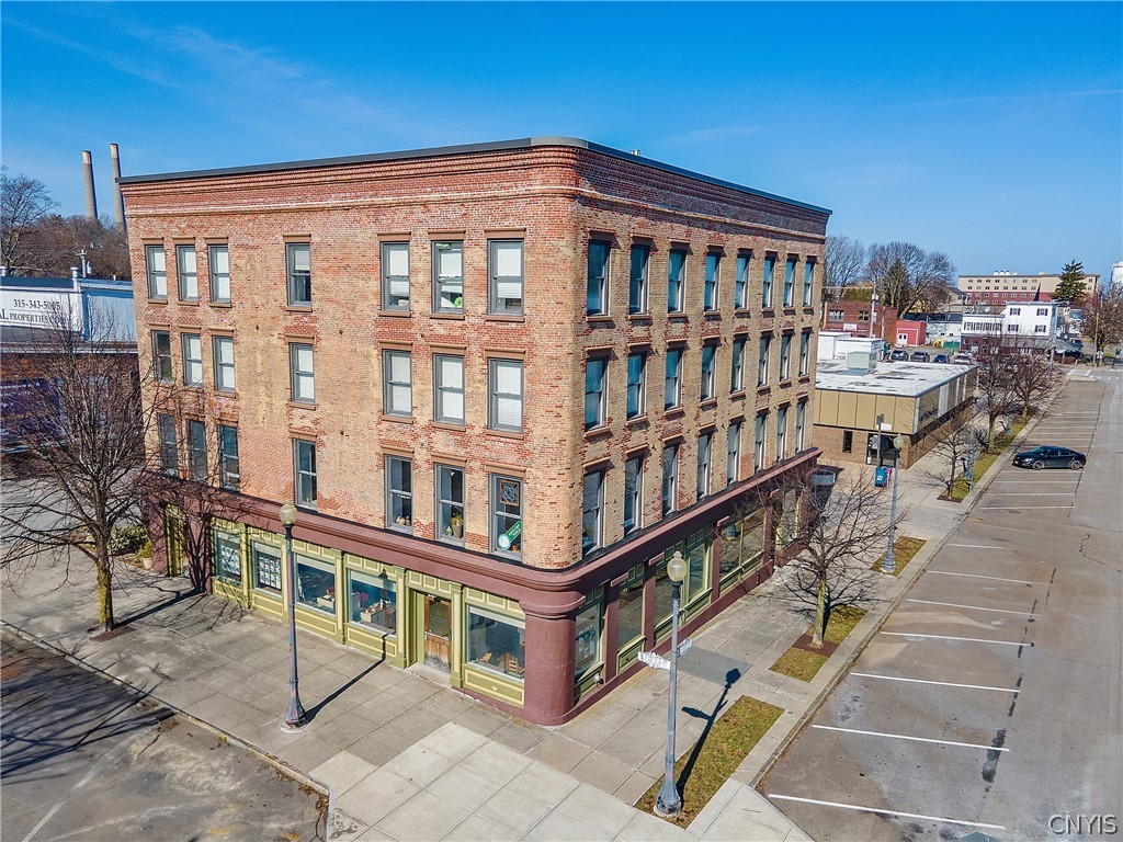 Incredible opportunity to own a beautiful and historic four story mixed use building in Downtown Oswego with combination of first floor commercial spaces, with residential apartments on the 3 floors above. This building is unique to Downtown Oswego, having its own parking available, in addition to street parking along the road frontage. Property has had low vacancy rate and generates significant annual revenue, with potential for an increase in revenue. Basement space is finished into a beautiful and successful longstanding restaurant and bar. First floor commercial space is currently set up as professional office space, but could serve a variety of uses - alternative plans drawn up for other possibilities, available upon request. The 7 residential apartments on floors 2, 3 and 4 with low vacancy rate, featuring six 2 bedroom apartments and one 1 bedroom apartment. 2,394 sq ft suite available for lease MLS# S1525907. Oswego NY is situated only approximately 30 miles from Micron's up to $100 billion dollar investment in Upstate NY, giving outstanding growth potential.