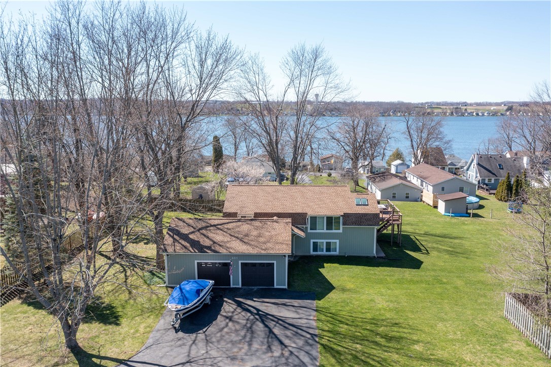 This Property offers a Wonderful Retreat w its Private Setting, Lake Views & Lake Access w BOAT DOCKING RIGHTS & SLIP! 68'x211' shared Lake Frontage! 5/10 MINUTES to I 390, GENESEO,Parks, Shopping & Award Winning Restaurants! Convenient for everyday needs while still offering a Tranquil Environment. 1/2 acre lot provides ample space for outdoor activities & a 2.5 Attached Garage. Open Floor Plan w Tongue & Groove Cathedral Ceilings creates a Spacious & Inviting Atmosphere. 1st Floor offers Family Rm, 3 Bdrms & a Full Bath. It could potentially serve as an In-law Setup or Space for Guests. 2nd Floor incls the PRIMARY BEDROOM & BATH w a Walk-in California Closet. Also Half Bath, Laundry, Large Living Room, Dining area & Spacious Kitchen w newer Appliances. NEW French Doors to the NEW TREX DECK W LIGHTS offers the Perfect Spot to Unwind & Enjoy Gentle Lake Breezes. This home has been COMPLETELY REMODELED incl NEW: Paint inside & out, Hardwood Floors, Windows, Roof, Gutters, Central Air, Driveway, Carpeting, Water Heater, Garage Doors, Drywall & Lighting. All 3 bathrooms have been remodeled! Turn Key!!! This home comes completely furnished w new beds & furniture. Boat & hoist for sale.