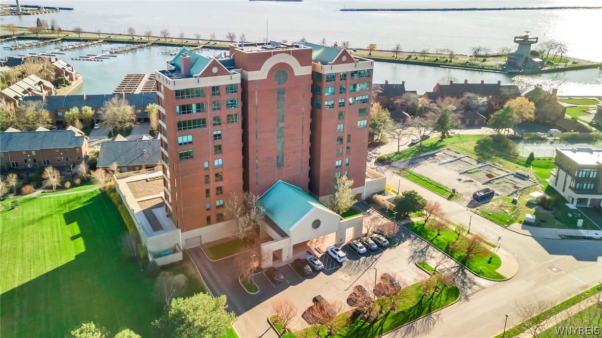 Absolutely stunning 4th floor condo in the city of Buffalo with spectacular view of the city skyline & Lake Erie waterfront. Unbelievably spacious 2 bedroom 2 full bath unit featuring a great open concept featuring tons of natural light & a private outdoor patio perfect for any summer night. The primary bedroom features great space w/ large closet & a stunning ensuite with a walk-in shower. The kitchen is fully loaded featuring stainless steel appliances, quartz countertops, tile backsplash, soft closed cabinets & a beautiful breakfast bar. The 2nd bathroom features great size & a huge closet perfect for all of your storage needs.  There is in unit laundry.  The entire unit was completely renovated in 2020 throughout. Newer heat exchanger & tankless hot water. This unit includes 1 garage parking spot with its own electronic charger & a secured storage space specific for the unit. There is also a full gym with a sauna available for the residence. Showings begin immediately and the offers will be reviewed as they are received.