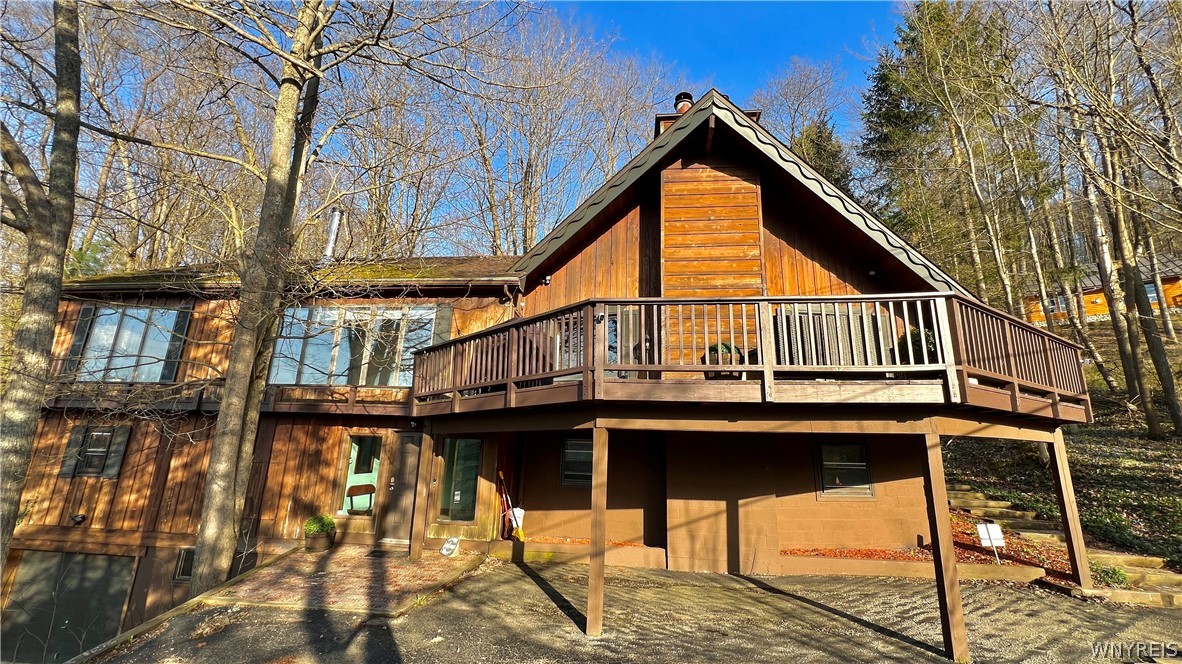 A great location for year-round fun and activities. Enter to your bright foyer, bringing you to all that ski/sports minded persons desire. The 1st floor has a large ski room with sauna, a great way to take that chill off! The area around your home has mountain bike trails, a short hike to a saddle pond; swim, paddle board and relax. A great floor plan with 6 bedrooms, 3 baths. The great room has large windows that brings the outdoors in with beautiful, distant views. The choice is yours, either a huge family room or a bedroom. Desirable open floor plan with large kitchen/dining area to the great room area for easy entertaining. Gather all your ski/mountain biking friends, it's THE spot to enjoy 4 seasons of outdoor fun. Huge primary bedroom with either a home office or additional sleeping area. Unwind in your outdoor Viking 6-8 person hot tub. Lower level makes a perfect game room. The attached garage is a huge plus. Spacious outside deck offers fresh mountain air and views. Paths take you to and from the ski slopes. Fully furnished for easy ownership. Ellicottville is a happy place, you love owning here! Good parking area at the main entry level. Location, perfect.  Spot on buy!