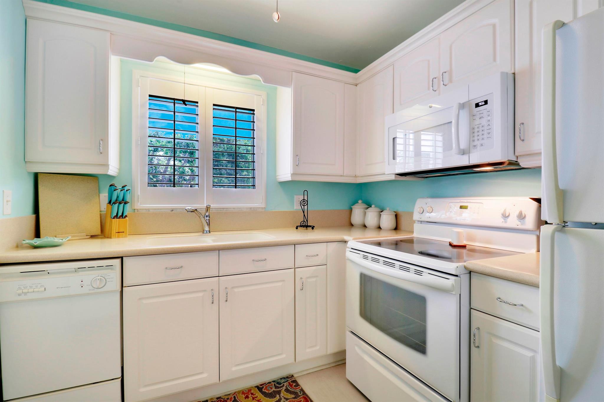 Furnished/Turnkey 55+ condo in the FABULOUS Village of Tequesta where there's always something going on. Enjoy the comfort and security of this updated 2nd floor 2 bd 2 ba END unit. Relax in extended 1072 sf Living area U/A with floor to clg sliders looking out to a lovely green area. New Vinyl plank flooring in living, dining & kitchen. Newer AC & Wtr Htr. W/D combo in the unit. Hurricane impact windows/sliders. Easy access to assigned parking space. Primary has walk-in closet. Community offers 2 swimming pools, shuffle board, putting green, clubhouse with billiards & social activities. Complex is NOT effected by 3 story structural reserve. Buildings are 2 storiesClose to beautiful beaches, fishing, restaurants, shopping, golf, tennis & more. PBI is