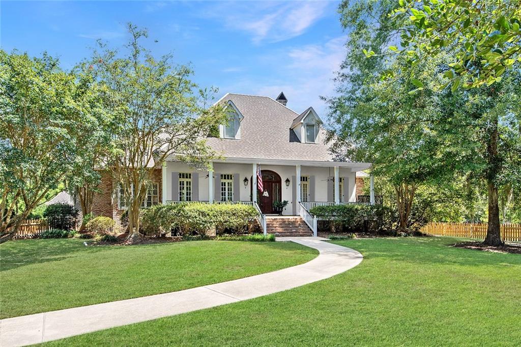 Discover a hidden 1.3-acre paradise with a sparkling pool, tucked away in the heart of Mandeville!! Approach the grand front porch and step into a world of beautiful craftsmanship where exquisite solid pine floors and majestic 12-foot ceilings greet you with timeless elegance. This custom-built home is a harmonious blend of charm and sophistication. The ground floor boasts a luxurious open kitchen, keeping area, and breakfast nook that create a seamless flow. Entertaining is a breeze with the butlers pantry and formal dining room. The Primary Bedroom has an inviting newly renovated en-suite bath, offering a serene retreat. A Guest Bedroom with a private bath ensures comfort and privacy for your guests. Upstairs, three additional bedrooms, a playroom, two beautifully appointed bathrooms, and an adaptable office space await. Whether for work or relaxation, the office and fifth bedroom offer the flexibility to suit your lifestyle. Outside, enjoy the screened-in back porch, the inviting pool, and an outdoor cabana with a half bath. This serene oasis truly captures the essence of a private estate, offering the perfect blend of relaxation and seclusion. Plus, most of the home's components have been recently updated—see the upgrades list in the attachments. Additional acreage is also available!