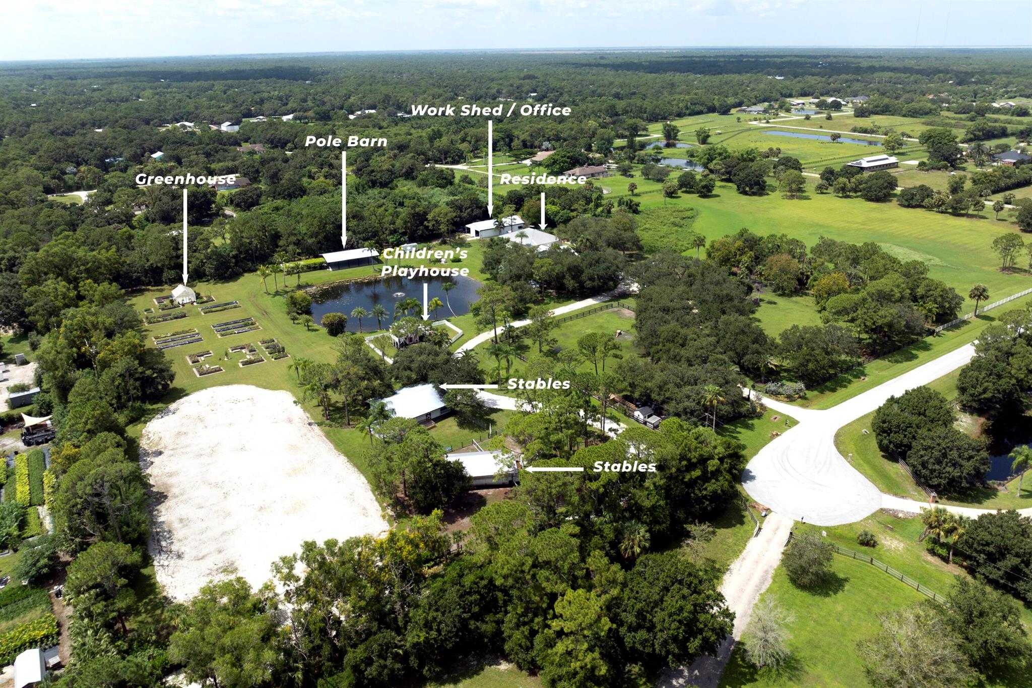 Welcome to The Seven Oaks Ranch, a truly enchanting 9.8-acre estate located at 5004 Southwest Martin Commons Way in the picturesque Palm City. As you approach this magnificent property, you're greeted by a grand, gated entrance that opens to a storybook setting. A tree-lined, winding drive meanders through the lush landscape, where dozens of majestic oak trees stand proudly alongside mature vegetation, creating a serene and private retreat. Nestled amidst this verdant paradise is a beautifully renovated, custom-designed 2-bedroom, 2-bath country cottage. The cottage exudes rustic charm with its screened-in front porch, perfect for sipping morning coffee while soaking in the tranquil surroundings. A charming back breezeway connects the cottage to an impressive 3,000 square foot, air-conditioned CBS Garage and Storage building, complete with a full bath. This versatile space offers endless possibilities! Store your recreational vehicles, boats, and cars or convert it into additional living quarters.  Whatever you decide, your options are endless.

Venture further, and you'll discover a second large storage building currently utilized as a workspace with farmhand living quarters, providing ample room for creativity and expansion.
For equestrian enthusiasts, this newly fenced property boasts three separate barns designed to accommodate up to 9 horses, along with six new paddocks, ensuring a comfortable and well-equipped environment for your four-legged companions.

As you explore the property, you'll find a charming gazebo overlooking a fountained lake, complete with a new fishing dock that invites you to unwind and enjoy peaceful moments by the water. The scenic beauty of this estate makes it an ideal setting for special events, and it is currently utilized as a sought-after location for weddings and other celebratory gatherings. With two gated entrances and parking capacity for approximately 150 cars, this equestrian estate is perfectly suited for an event-hosting business.

Along your winding path lies a storybook two-story playhouse, sitting like a whimsical cottage straight out of a fairy tale. Here, the laughter of children fills the air as they embark on imaginative adventures within their own little world. This charming playhouse, surrounded by a white picket fence, is a miniature wonderland, complete with quaint shutters and a tiny front porch. Inside, the magic comes alive as the little ones scurry up the ladder to the second floor, peeking out from the windows like explorers surveying their kingdom. Downstairs, they host tea parties with their stuffed animal friends or set up a pirate's den, plotting their next grand adventure. More laughter and giggling can be heard outside as they slide down a 360-degree spiral slide. This enchanting playhouse is more than just a structure; it's a place where imagination knows no bounds and every day is a new chapter in their own delightful story.

Currently zoned for 3 acres of agriculture and 7 acres of residential use, this versatile property offers endless opportunities for those seeking a unique lifestyle or a profitable venture. Whether you envision it as a private sanctuary, a bustling event venue, or an expansive equestrian estate, this luscious and elegantly manicured property is a rare gem that promises a life of tranquility, beauty, and boundless potential.

Welcome home to your dream estate, where every corner tells a story, and every day brings new adventures.

This is a turn-key, working farm opportunity.