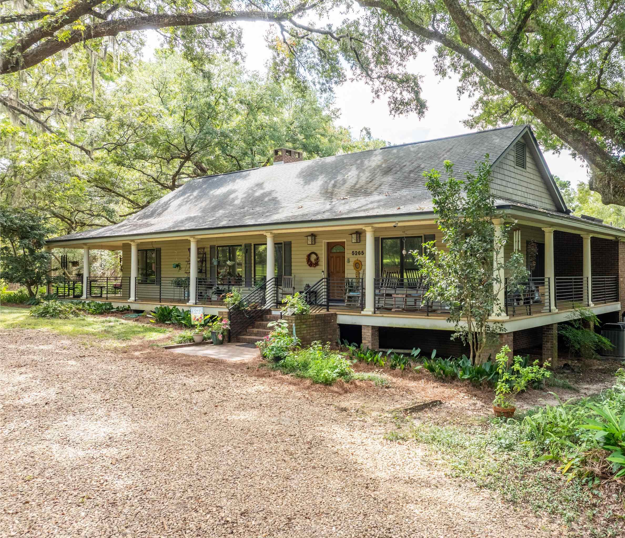 Picturesque 4 bedroom, 3 bath farmhouse with a wrap-around porch, a pollinator garden, and surrounded by mature live oaks, this homestead includes a 48'x36' pole barn, and an income producing duplex. 20 acres with enough privacy to enjoy nature, but still convenient to downtown and shopping, this unique property is being offered for sale with the adjacent 19.78 acre parcel for a total of 39.78 acres. Don't miss this wonderful retreat.