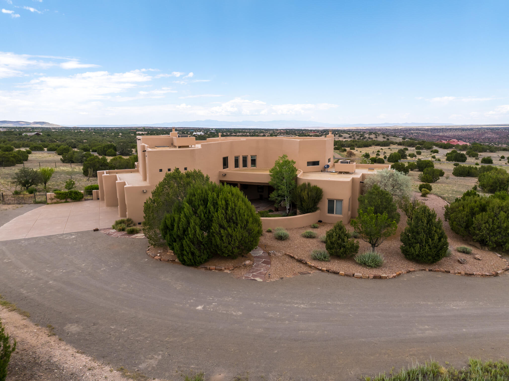 Imagine a home designed to capture the essence of East Mountain living on 10 acres, where expansive walls of glass blur the lines between indoors & out. This custom-built masterpiece boasts soaring ceilings with handcrafted wood beams that amplify light and openness, while every window offers a breathtaking vista. This beauty with a fabulous open floor plan, originally built for the builder, with many custom features. Certified Green Build with ICF Construction and Turkish travertine floors, Pella wood windows, magnificent 22' Kiva in Living room, Chef's kitchen with high-end Kitchen Aid appliances, Thermador Professional range, tons of counter space & butcher block island. Covered patio with kiva fireplace, 4-car oversized garage, fenced yard (2/3 ac) Roof-top deck on 10 acres.