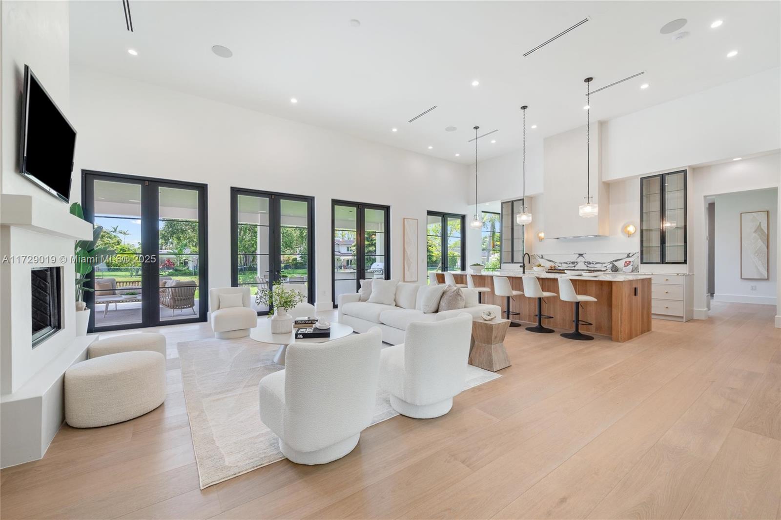 Exquisite Pinecrest residence just completed with CO ready for immediate occupancy! This contemporary modern farmhouse is one of a kind sitting on a quiet dead-end street with canal on 2 sides. Integrating a seamless indoor/outdoor living experience with natural white oak wood floors which blend the immaculate architecture & expressive details. With 6,389 SF this home includes 4 full bedrooms plus an office downstairs, 1 bedroom upstairs plus a flex space which can be used as a guest quarters, gym, office and/or home theater. 5.5 bathrooms inside main home plus full cabana bath. Must see it in person to appreciate! 2 car garage with lift space.