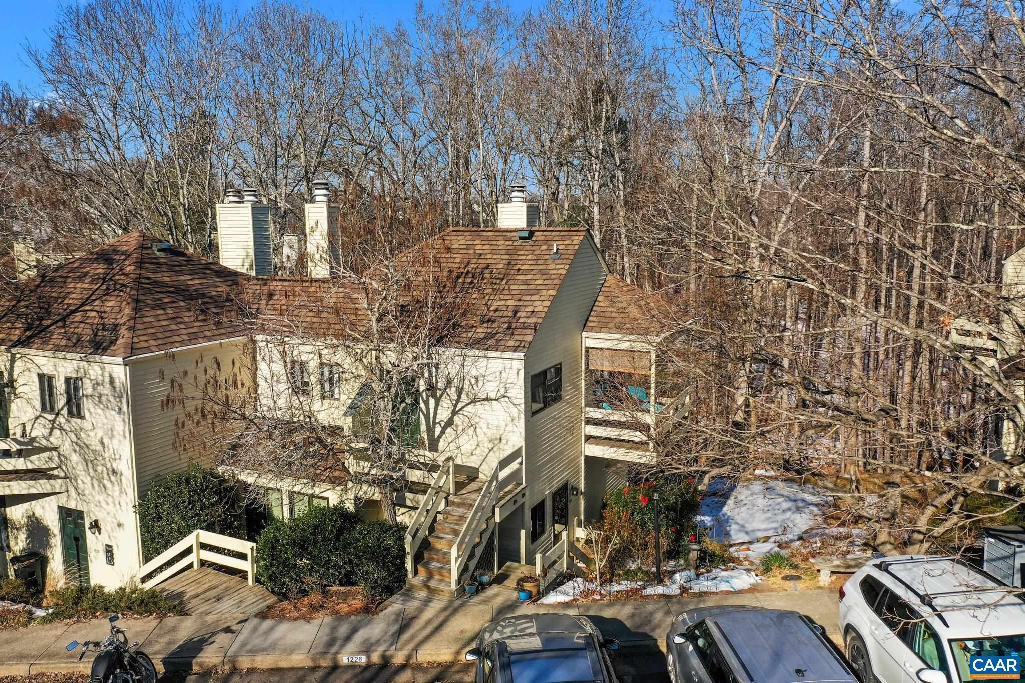 **Saturday Open House 12-2; Sunday Open House has been cancelled**Adorable Condo provides perfect space for easy living with a primary bedroom, en suite bathroom/laundry and living area all on one level. (THERE ARE STEPS TO THE CONDO) The tall ceilings and plentiful windows let abundant natural light fill the space, and the deck overlooks the forest for peaceful morning coffees. Located in River Run, this home is convenient to the downtown mall (a mere two miles away!) and everything that 29N has to offer! A wood burning fireplace adds to the coziness of this darling abode. New roof 2021, New dishwasher 2023, New water heater 2024.   HOA INCLUDES: Area Maint, Exterior Maint, Insurance, Pool, Prof. Mgmt., Road Maint, Snow Removal, Trash Pickup. $117 is paid to River Run association and $165 is paid to the Chatham Ridge association monthly