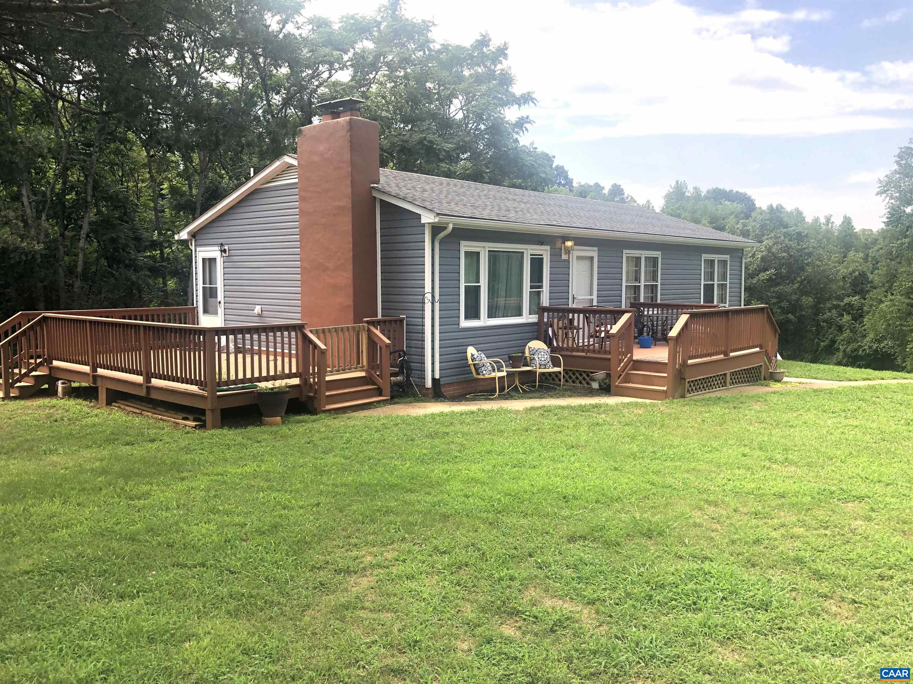 Seeking flexibility, space, or investment potential?  Two homes, endless potential with renovated guest house and spacious main residence on 2.53 acres.  This is a rare property just minutes South of Charlottesville.  The main residence is a beautifully maintained 3 bedroom home with a fully renovated 1 bedroom guest house ideal for multi-generational living, passive income or an inspiring private workspace. The guest house has been tastefully upgraded from top to bottom - solid hardwood floors, living room & custom eat-in kitchen with handcrafted cabinetry, 1 full bath, 1 bedroom & laundry room with flexible use as an office, studio or hobby space. New porches & roof, crisp interior/exterior paint completing the transformation - turnkey & full of charm.  Well maintained & upgraded main home has over 2,000 sq ft of comfortable living - 3 bedrooms, 1.5 baths, open concept layout & full unfinished walk-out basement w/cement patio offering a welcoming atmosphere that feels like home. Step outside to enjoy private yard w/mature trees and ample space to relax, garden or entertain.  Both homes are ready for modern living.  Live in one home and rent out the other!