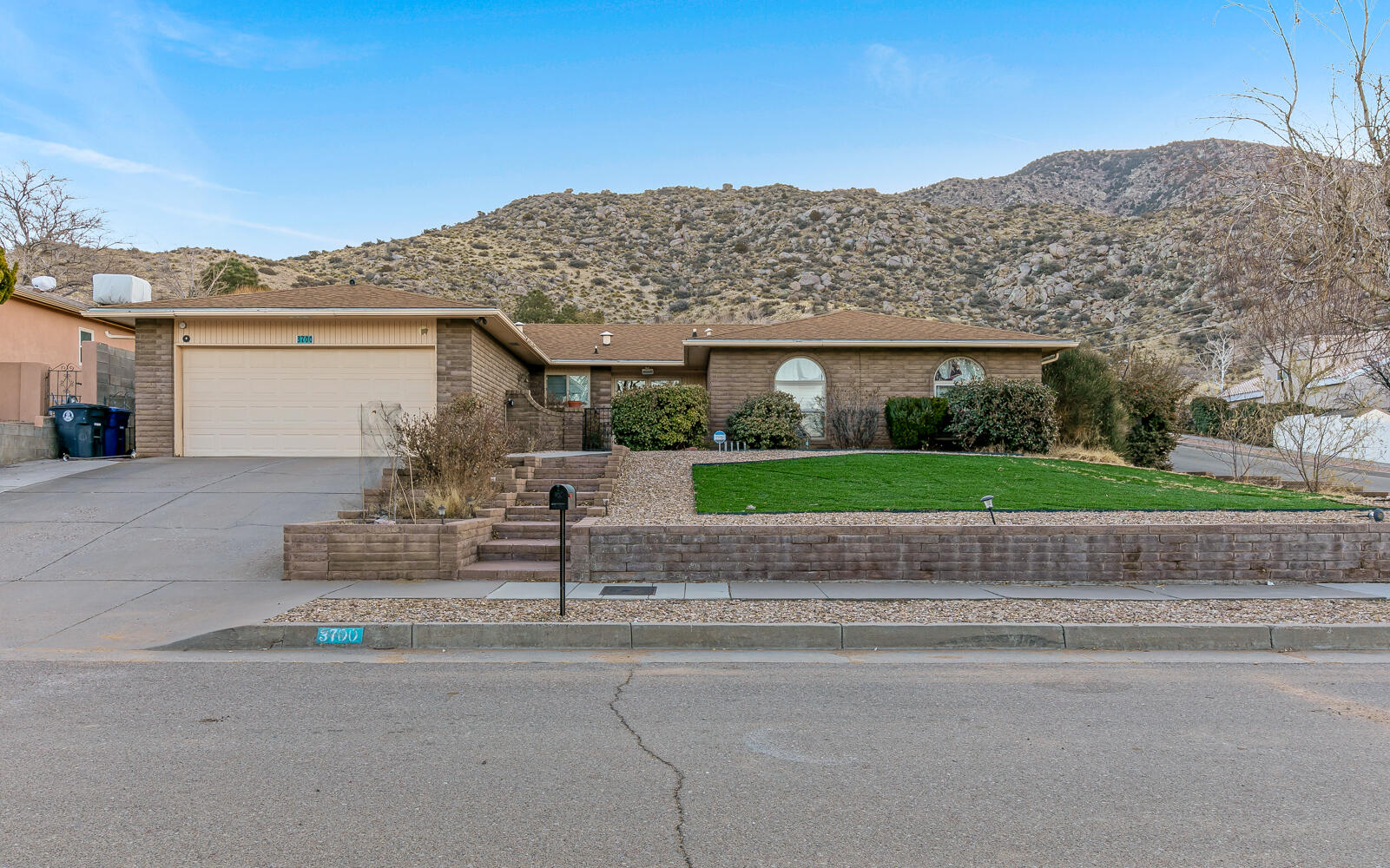 Lot's of repairs have been made to make this single story nestled in the foothills, the perfect picturesque home against the Sandia Mountains. Beautiful hardwood floors greet you as you enter, as well as a sunk-in living room. 2 living areas, one with a cozy wood burning fireplace. Kitchen has solid surface counter tops, and refrigerator stays. Large primary suite with walk in closet. Good size bedrooms.Skylights give it great natural light. REFRIGERATED AIR! Private backyard with putting green. Just 1 block from the base of the mountain, so there is easy access to hiking trails. Just minutes away from shopping, restaurants and YMCA. Quiet area with  scenic backdrop. Repairs completed and it's ready to go!
