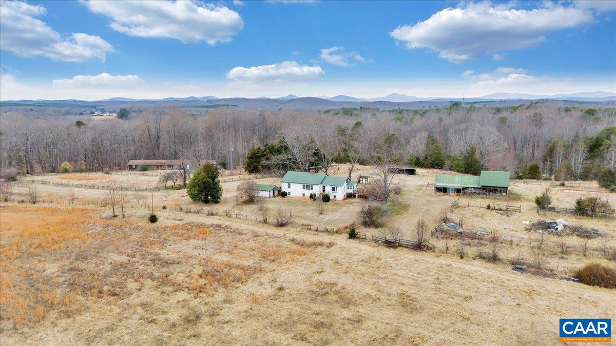 Chermont- a 30-acre estate featuring a blend of open pastures and mature woodlands. The property includes a 5-stall barn, hay storage 16 x 12 upper, 36 x 16 tractor / equipment area at end of barn, a detached 1-car garage, and an apartment building with three 1-bedroom, 1-bath units—ideal for rental income or multi-generational living. The main residence boasts 3 bedrooms, 1.5 baths, a living room, dining room, and kitchen on the main floor, plus a lower level with 2 bedrooms, 2 baths, a den, and a kitchenette. Additionally, the apartment building offers 1,560 sq. ft. of storage space on the main level and a sprawling 3,600 sq. ft. unfinished basement. While all dwellings require renovation, this unique estate presents an incredible opportunity to create your country getaway.