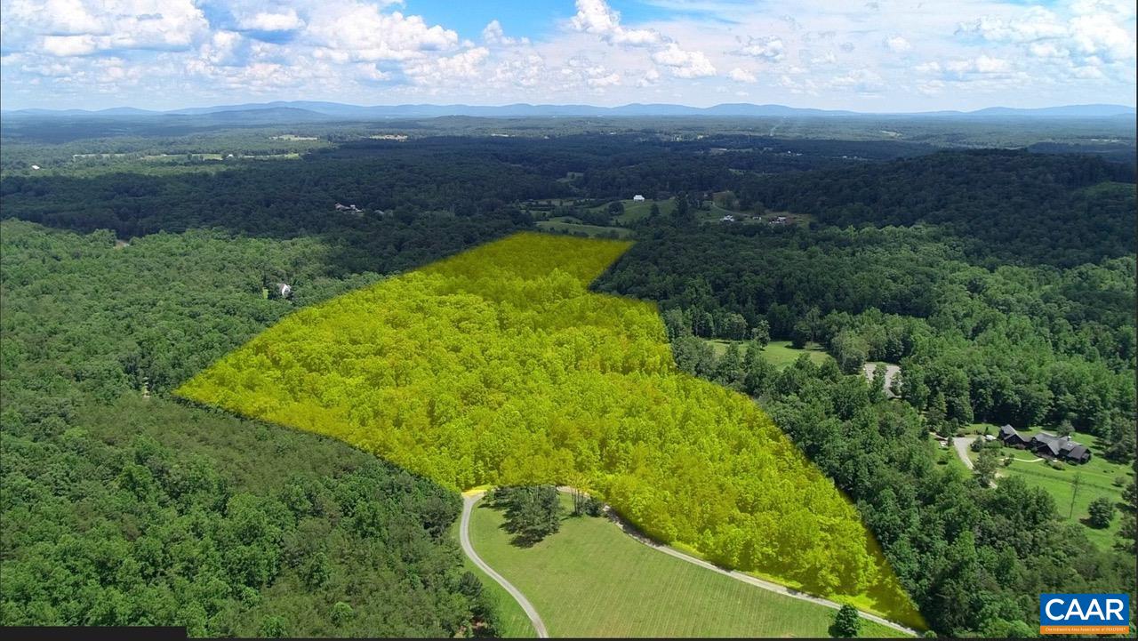 This wooded parcel is tucked away near the end of a private, gravel road. Owners have recently cleared an elevated, level site that offers privacy but has easy access off the country lane. The property is well-watered with two branches of a strong stream running through the property.