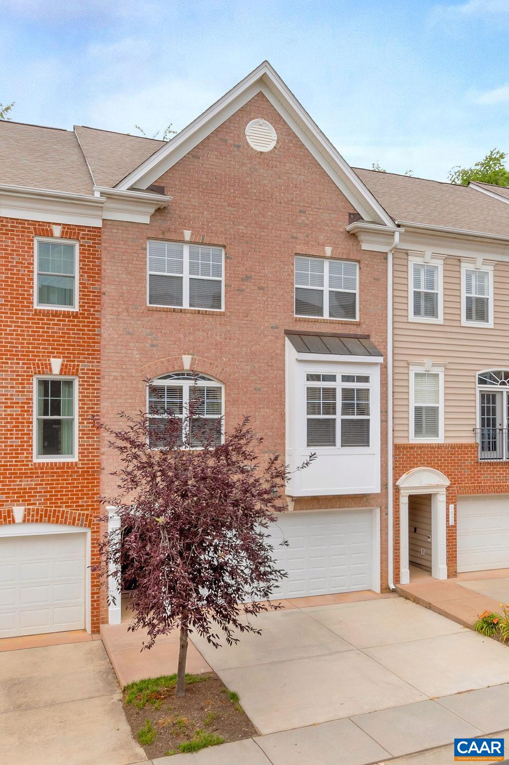 This lovely Gaffney built townhouse is move in ready! Hardwood floors, back deck, flexible floorplan and a private exercise room and swimming pool await! The location has excellent proximity to all that C'ville has to offer. Quality upgrades include-sunny kitchen w/ white cabinets, black granite counters, tile backsplash, stainless + eat-in dining. Real Oak hardwood floors and tile throughout (no carpet), 9' ceilings, extensive trim work, tile baths, gas fireplace + 2 car attached garage. Open floor plan offers wonderful flexibility: family room, living room & formal dining areas include cozy spaces for home office or play area. Living room opens to spacious deck backing up to trees for shade & privacy. Lower level features bedroom/office w/ walk-out to back patio + ready to be finished full bathroom. Potential private suite, no steps entry level.The home has a very good spacious feel to it. There is still time to settle in to enjoy the pool this summer! Woodbrook Elementary school location! 3.88% assumable VA mortgage possible! Motivated Seller.
