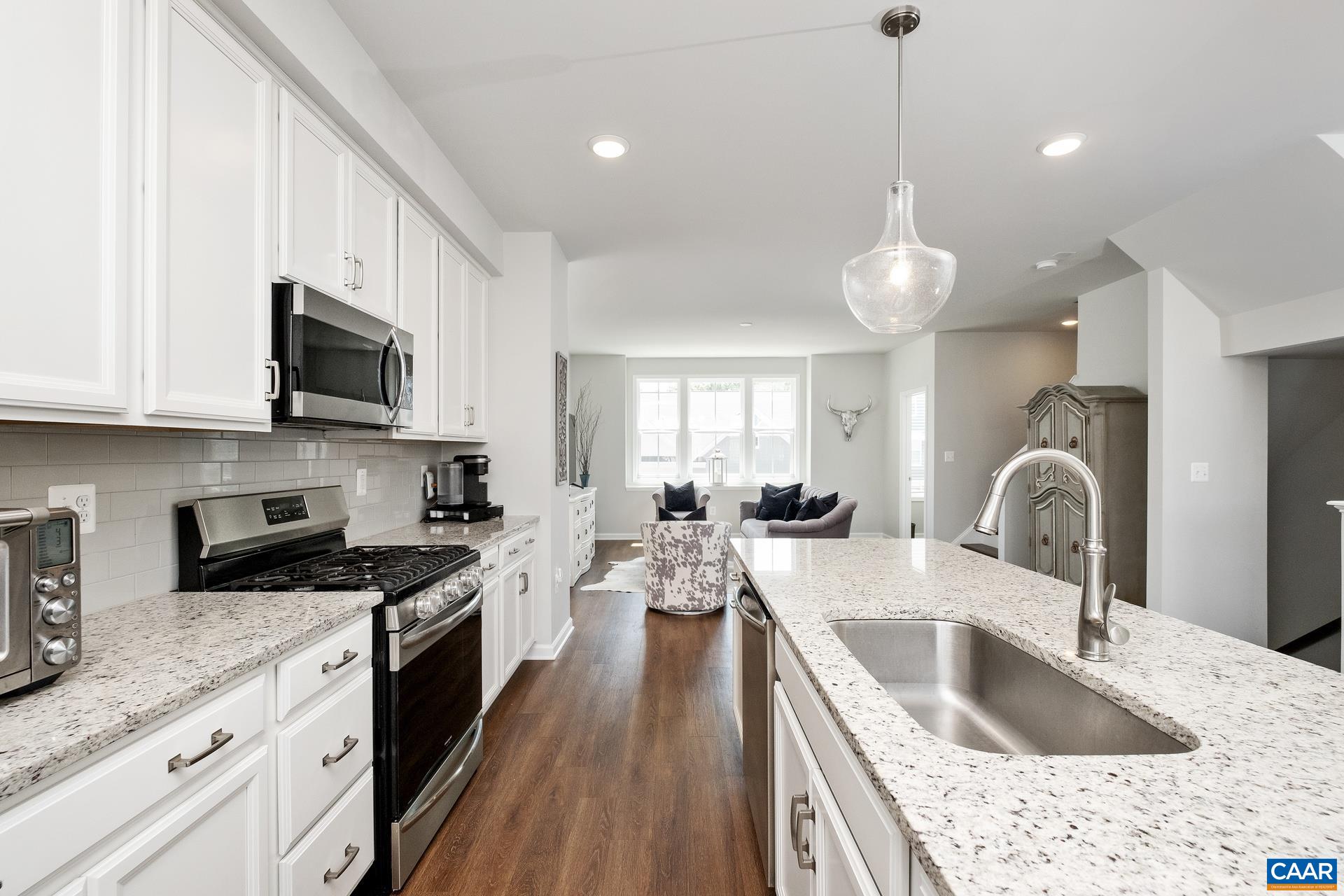 Motivated seller due to a relocation! This beautiful luxury end-unit home has everything you want. As you enter the house you are greeted in a light filled foyer. The bottom floor has a great multi-purpose room which is the perfect guest suite with attached bath or additional large family/recreation room. Upstairs you find the open floorplan including your living room, dining room & upgraded gourmet kitchen with oversized island. Perfect for entertaining inside & out with a lovely deck with plenty of space to cookout or relax. Head up to the bedroom level. There you will find a large master bedroom with two closets including a walk-in & master bathroom with double vanities & beautifully tiled shower. Two more bedrooms including one with another walk-in closet, bathroom, & laundry complete that level. As a bonus, the pulldown attic stairs lead to additional storage space which is a rarity in a townhouse. Perfect location minutes from UVA, Downtown, Wegmans, & I-64. The Avinity neighborhood is a true community where neighbors know each other. Enjoy the dog park, clubhouse, playground & full gym or meet your neighbors at a wine social or the weekly food trucks. Come see your new home today!