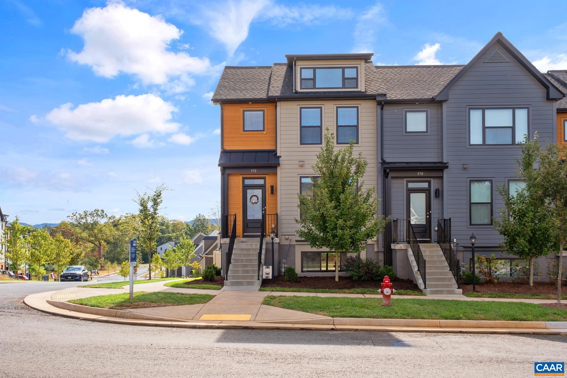 Stunning 3-level, end unit townhome offers 2 ensuite bedrooms, 2-car garage, and mountain views! The main level features hardwood flooring, an abundance of windows for natural light, and an open kitchen, outfitted with stainless steel appliances (gas range/french door refrigerator), granite countertops, and a vented hood. Upper level boasts the master bedroom with vaulted ceiling, dual-vanities bath, and a walk-in shower, two additional bedrooms, full bath, and a dedicated laundry room. Ground level includes an additional bedroom and full bath perfect for guests. HOA covers gigabit fiber internet from Ting! The Belvedere neighborhood features multiple greenspaces, playscapes, access to Rivanna trails, SOCA Field House, the Center at Belvedere and more! Why wait to build when you can own this like-new townhome perfectly located for beautiful sunrises and sunsets. Come call 972 Belvedere Blvd. home, you will not be disappointed! Open House 10/15, 2-4pm!