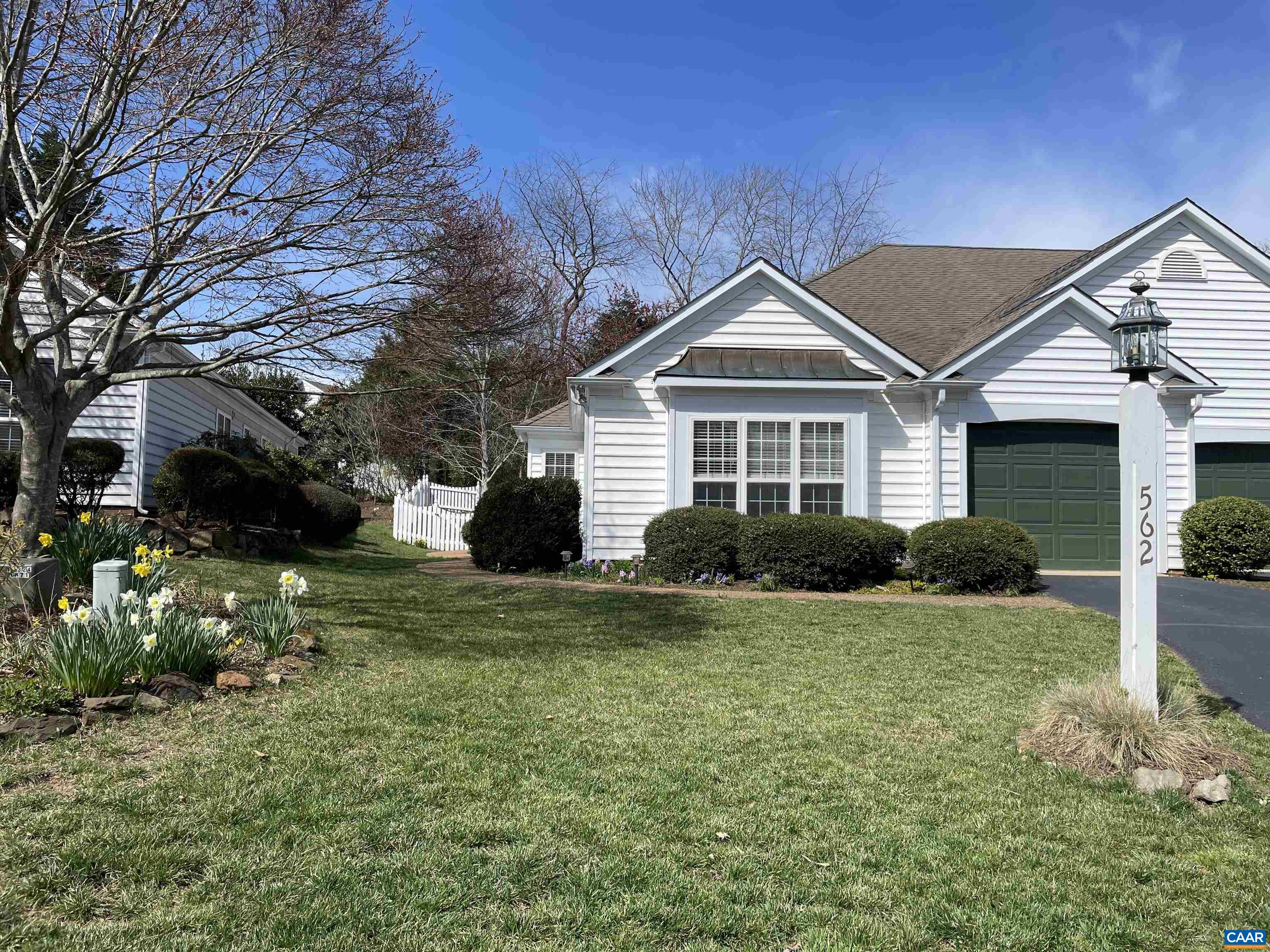 Peaceful living in the heart of Charlottesville! Tucked away on a quiet cul-de-sac road in a centrally located neighborhood, this one level townhome provides a quiet sanctuary while being minutes from 5th St. Station, Wegmans, UVA and downtown. The open floor plan flows seamlessly from the large sunny eat-in kitchen to the formal dining area to the beautifully appointed living room with a soaring vaulted ceiling, a gas fireplace and French doors leading out to the private back patio. Two spacious bedrooms with ample closet space, two full baths and an additional room that can be used as an office, playroom or guest room round out this warm sun-filled home. Professionally landscaped with mature hedges, seasonal flowers, a stone wall and charming white picket fence are lovely low maintenance outdoor touches. Neighborhood amenities such as walking/running trails, a playground and pool are within walking distance.