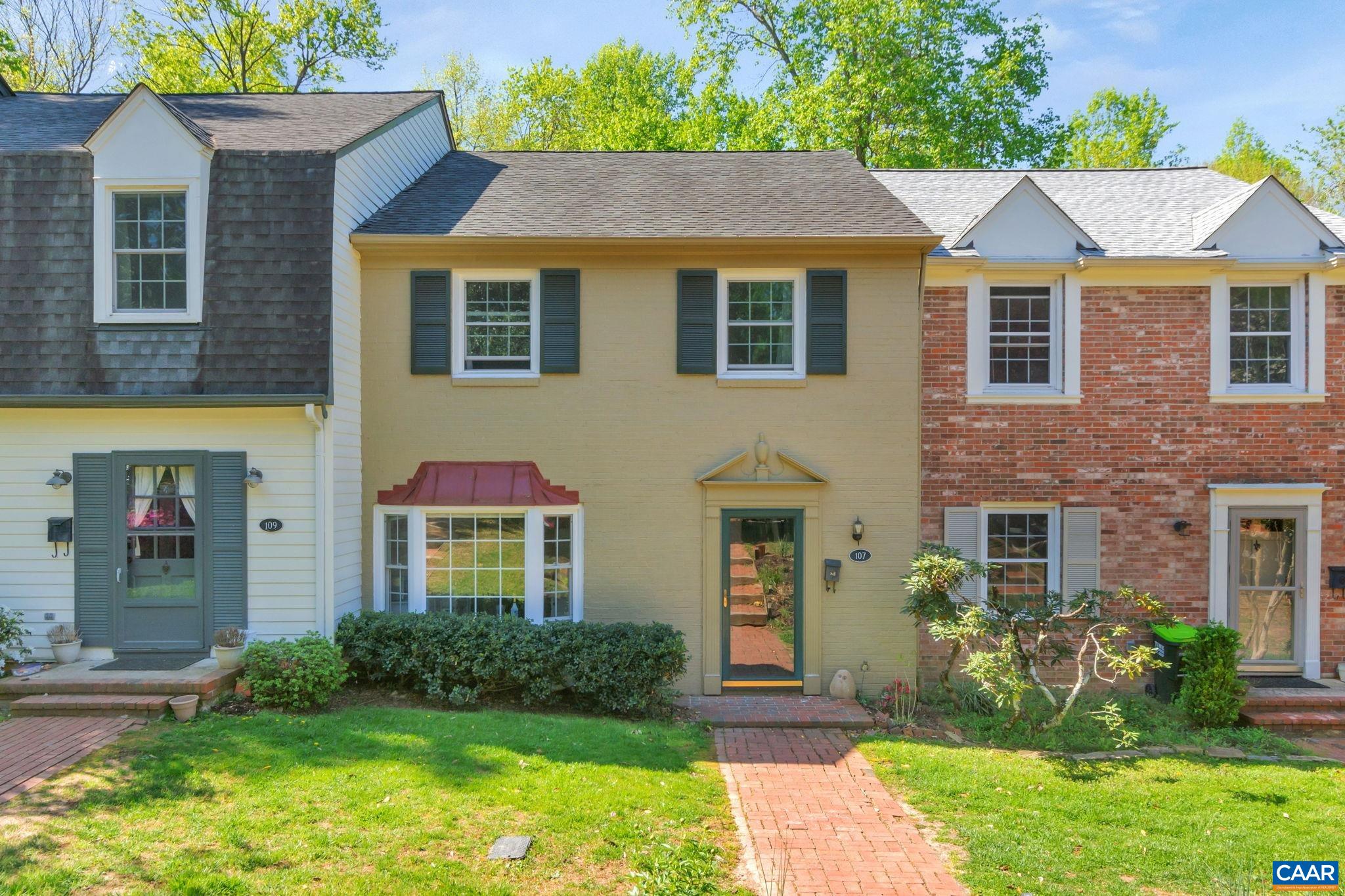 Classic Colonial row home within walking distance to Albemarle High School and minutes to grocery shopping, retail, UVA grounds and downtown Charlottesville.  Recent updates include but not limited to new LVP flooring throughout main level and basement of the home. White subway tile kitchen backsplash. New Pella windows throughout. Classic white tiled showers in full baths. Updated lighting. The living spaces in this home are generous in size allowing for easy furniture placement. The laundry room includes a large area for storage/workshop/crafting or hobby area. Outside of the basement living room is a brick patio and small yard that backs to communal grounds and woods! Georgetown Green has a playground area, pool and basketball hoop area. The HOA includes exterior maintenance, roof, lawn care, amenities, trash and cable though TING is set to install fiber internet in JUNE. Seller providing a one year home warranty!