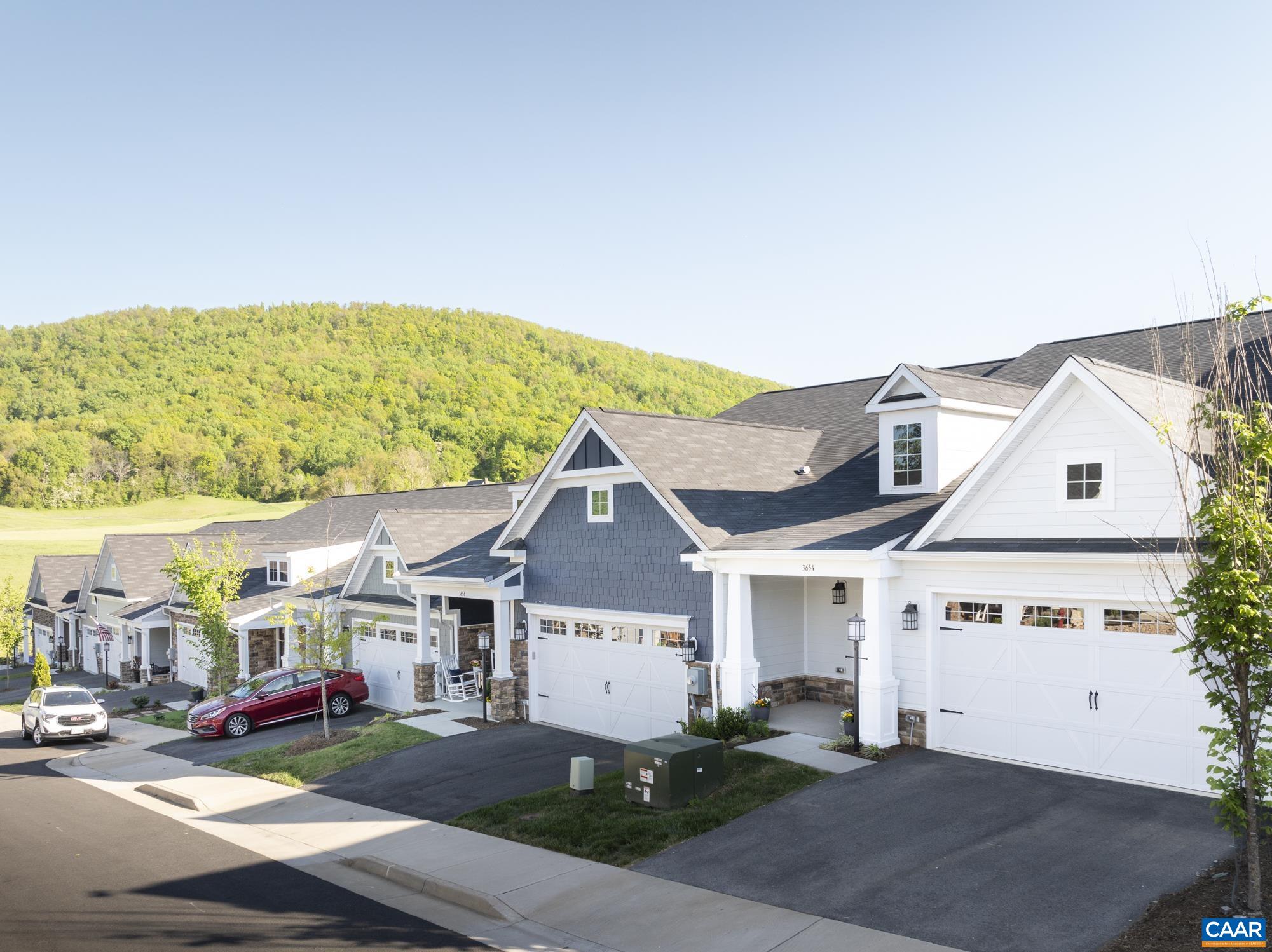Enjoy lovely mountain views as you come and go from this light-filled villa constructed in late 2021. Just over 2 years old, this practically new home has been meticulously cared for and lightly lived in. Located on the south side of Charlottesville in the popular Avinity neighborhood, where neighbors frequent the community dog park, playground, and gym. Inside find a spacious open floor plan with first floor primary for main-level living. Bright, modern kitchen finishes include white cabinets, granite countertops, decorative tile backsplash, and stainless steel appliances. The living area opens to a private backyard with patio and mountain views. First floor primary suite offers a glass shower with tile surround, dual vanities, and separate water closet, along with a spacious walk-in closet. Also on the first floor are a half bathroom, laundry room, mud room drop zone, and two-car garage. Upstairs find two additional bedrooms and a spacious hall bathroom with dual vanities, along with a large linen closet for plenty of storage. Within close proximity to downtown, I-64, Wegman's shopping center, UVA Hospital and Martha Jefferson Hospital, this location is hard to beat!