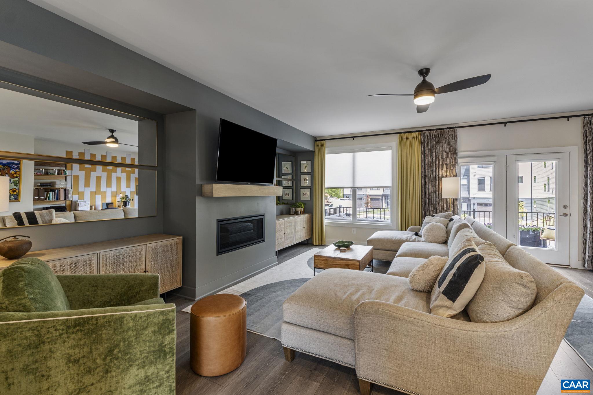 This contemporary designed home has an open floor plan with sun-filled spaces.  Its sophisticated interior affords a sizable rec room that can be used as an office or guest suite with full bath. Gourmet kitchen with an oversized island, granite countertops, maple painted cabinets, and stainless appliances. Stylish family room with custom paint and gas fireplace. Dining room with ample space for a large family gathering and a chic-style office area. The main level space is banked by large windows/doors and accompanied by custom drapery which adds warmth and privacy. Primary suite lives large and airy with vaulted ceilings, dormer windows, and custom installed blinds. Rear fenced-in yard and trex deck presents great space for entertaining. Garage and off-street parking, too.  Fenced in rear yard, new custom curtains and blinds, felt wall, deluxe refrigerator washer/dryer, and additional landscaping (these items were completed by owner after closing)