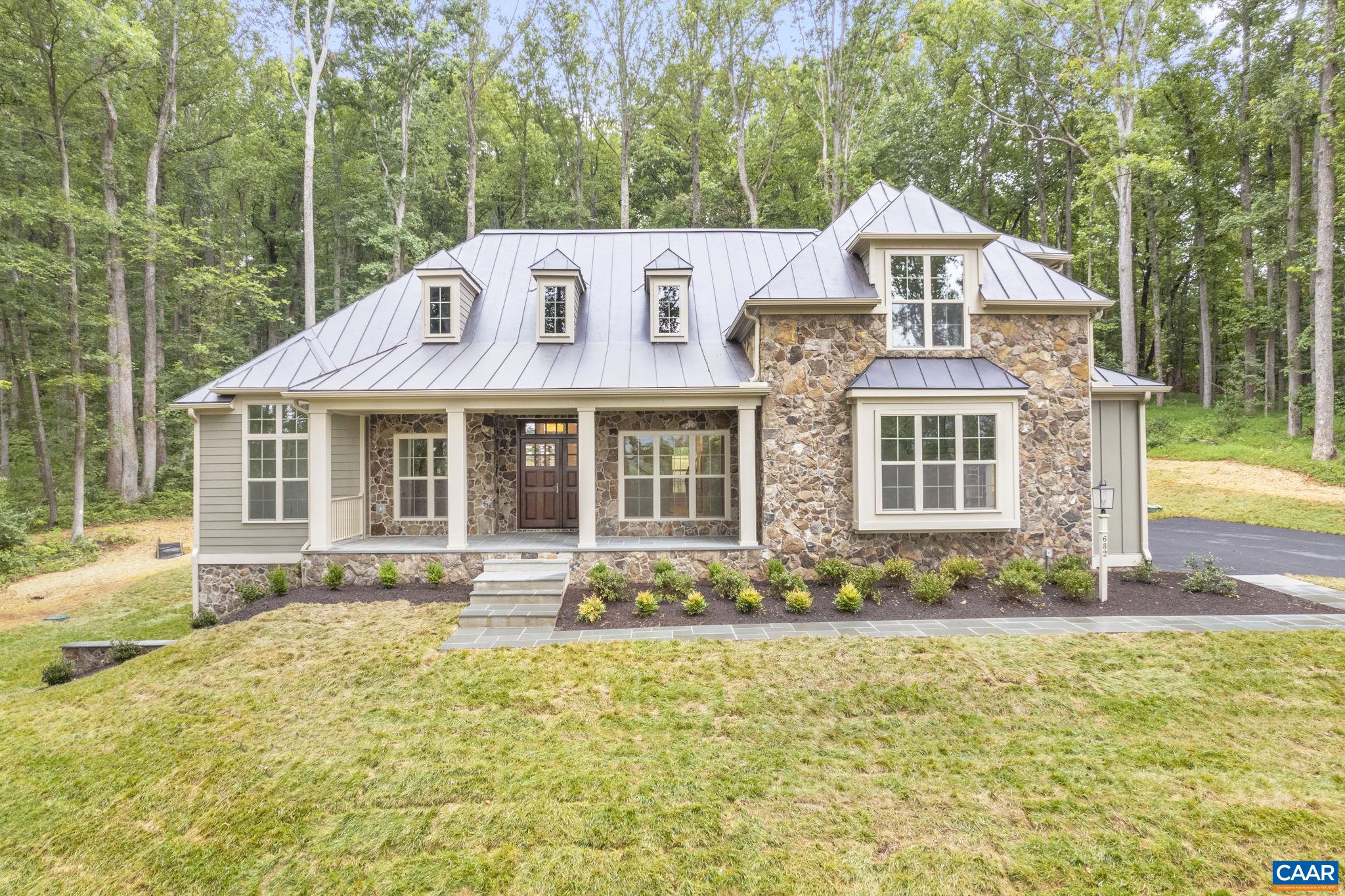Pre-Sale Newport with August 2025 Closing. Unique offering in this premier, established community on a wooded, 5 acre homesite, convenient to UVA and downtown. This ‘Newport’ plan offers an open floorplan with a stunning Great Room that boasts a cathedral ceiling and tons of windows to maximize natural light. Walkout basement with finished basement recreation room & full bath included. Quality built 2×6 exterior walls, custom mahogany front door, R-19 insulation, and standing seam metal roof. Kitchen includes painted maple cabinetry (white, gray, etc. shaker style), granite countertops (also in primary suite), and much more. Photos are of previously built model home. New Construction with no construction loan needed– with deposit Builder will fund the build so that purchaser may obtain the same type of loan as if they bought a resale. Builder also offers a streamlined process to make planning your move easy with a known move in date upfront. On-staff draftsman for plan customizations.
