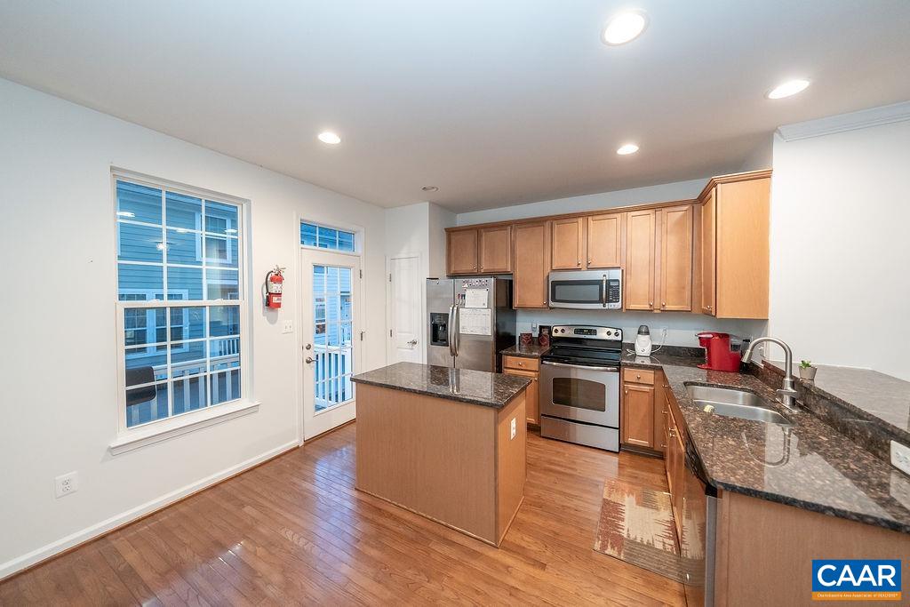 The location and condition of this wonderful townhome help surround you in an atmosphere of convenience in western Albemarle County! Granite countertops, stainless steel appliances, and maple cabinets help create the focal point in the kitchen while the elegant crown molding only enhances the space throughout the main living level and lower level. The amazing hardwoods only help complement things further. Beautiful vinyl tile flooring was placed on the lower level and third level. The 9' ceilings provide the benefit of keeping the spaces open and bright. The current owner also added the half bathroom on the lower level to even better utilize the efficiency of this unit. At this price point, the one-car garage is a huge benefit! This townhome is located literally across the street from the Blue Ridge Shopping Center with Harris Teeter and the Clover Leaf Shopping Center. Both of which offer so many businesses and activities. Liberty Hall HOA covers trash service, lawn care, and snow removal.
