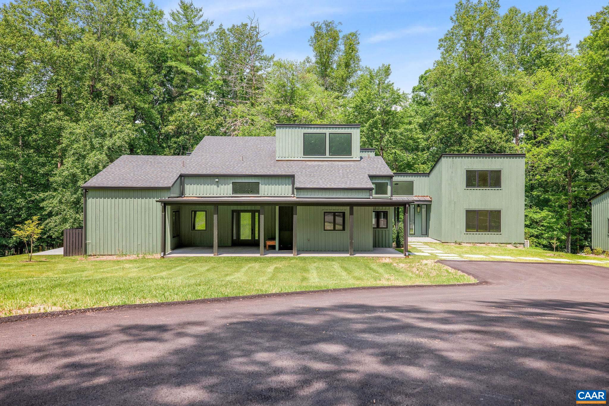 Stunning, completely renovated architecturally distinguished modern contemporary home on 11.05 acres with bold Blue Ridge winter views! Flawless upgrades & renovations have taken this exceptionally well-built, architectural gem to a supreme level of style & quality. The home features beautiful high end finishes throughout with 5 bedrooms, soaring interior spaces, 2 first level primary bedrooms (one guest suite). 2nd level offers 3 bedroom, 2 bath (one en-suite) with multiple space for the creative. Enjoy coffee, drinks and dinner on any of the 4 porches including one large covered wrap around porch. Gorgeous new kitchen features premium custom cabinets (Viking appliances) that connects seamlessly with the open great room, the cozy family room, wet bar and the outdoor spaces. The second primary suite (guest suite) with second floor office/workout is separate but connected via glass walkway to the great room and kitchen. The great room with a beautiful fire place as its focal point is perfectly complemented by the cozy family room with its own fire place. Great room, family room and primary suite all connects to the covered porch. Located on 11+ private acres off Garth Rd surrounded by land in conservation.