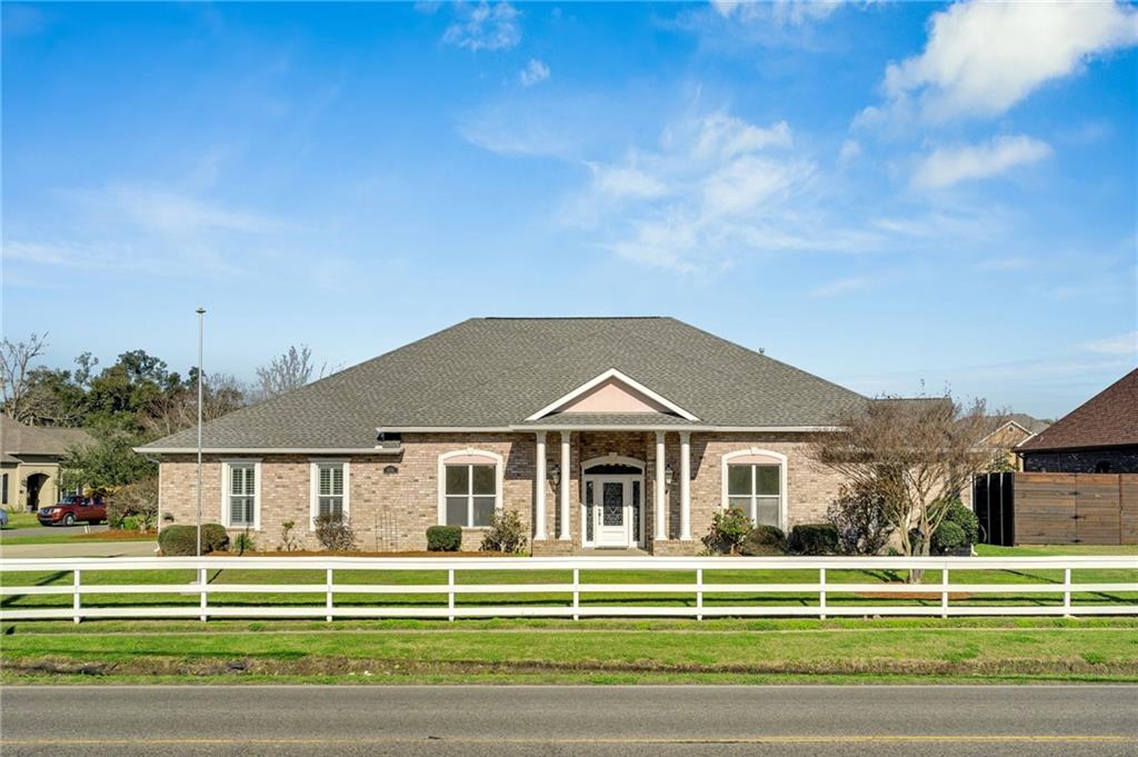 This gorgeous custom built, impeccably maintained one owner home in pristine condition welcomes you! Enjoy the view of the serene grandeur of the Mississippi River levee from this oversized corner lot in a small friendly neighborhood, located just 1 mile from the historic Destrehan Plantation. This 4,000+ square foot home includes 4 bedrooms downstairs including two nearly identical primary  suites. Leisurely entertain your family and guests with an open living area that blends into a gourmet kitchen, island, breakfast bar, and seated snack/breakfast area. The bonus room for an office, library, or private conversations is steps away. A 35' sun/living room provides even more area for casual entertaining, while the whole house 22kw generator keeps consistent comfort and lights!  The huge second floor fifth bedroom is great for a gym, theater room, play area, or just keep as a bedroom with its own full bath and closets. Outside you will find a permanent gas grill, fenced dog run, and a detached garage/workshop, convenient for storing lawn maintenance equipment and recreational vehicles. There is a half bath included there too! You can park your boat or camper under the carport (which has tie down rings) the paved parking area accommodates 20 vehicles for some serious fun times with friends and family! Convenient access to both I-10 and state routes makes for an easy commute to most anywhere. A superior school system, great amenities and natural beauty of the area makes your new home ownership dreams come true!