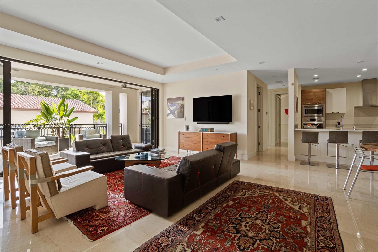 Experience contemporary elegance in this stunning 2-bedroom, 2.5-bath residence with a den at Biltmore Parc. Designed with an open layout, abundant natural light, and private elevator access, it blends luxury and functionality. Built in 2017, this exclusive 32-unit building offers a 24-hour concierge, secure entry, two reserved parking spaces, and generator-ready capability. Expansive terraces with NanaWall glass doors enhance indoor-outdoor living. The European-style kitchen features Bosch appliances, while the master suite boasts walk-in closets and a spa-inspired bath. A walk-in laundry room adds convenience. Walk to Coral Gables' top dining, shopping, and parks.