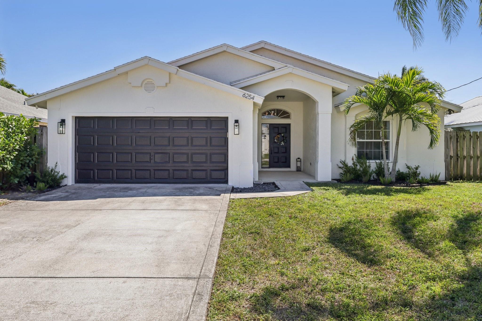 Meticulously renovated 3 bedroom, 2 bath, 2 car garage CBS home with over $150k in upgrades. Crafted as a forever home, no detail was spared. The designer kitchen features a custom hood, solid wood cabinetry, oversized 8ft island, leathered titanium granite & quartz countertops, wine fridge, and GE Café appliances. The open concept living area boasts 12ft vaulted ceilings, LVP flooring, and French doors leading to a screened in patio, perfect for entertaining or relaxing. The primary suite includes vaulted ceilings, French doors, a spa style en suite bath, and generous walk in closet. In the front wing, two additional bedrooms share an upgraded, spa like bathroom with double vanity. NO HOA. Minutes to top-rated schools, beaches, Abacoa, Alton, shopping & dining. Full renovation completed between 2023-2024 
Impact windows & doors
AC 2021
Air ducts 2022
All appliances 2023
Wine fridge 2025
Washer & Dryer 2023